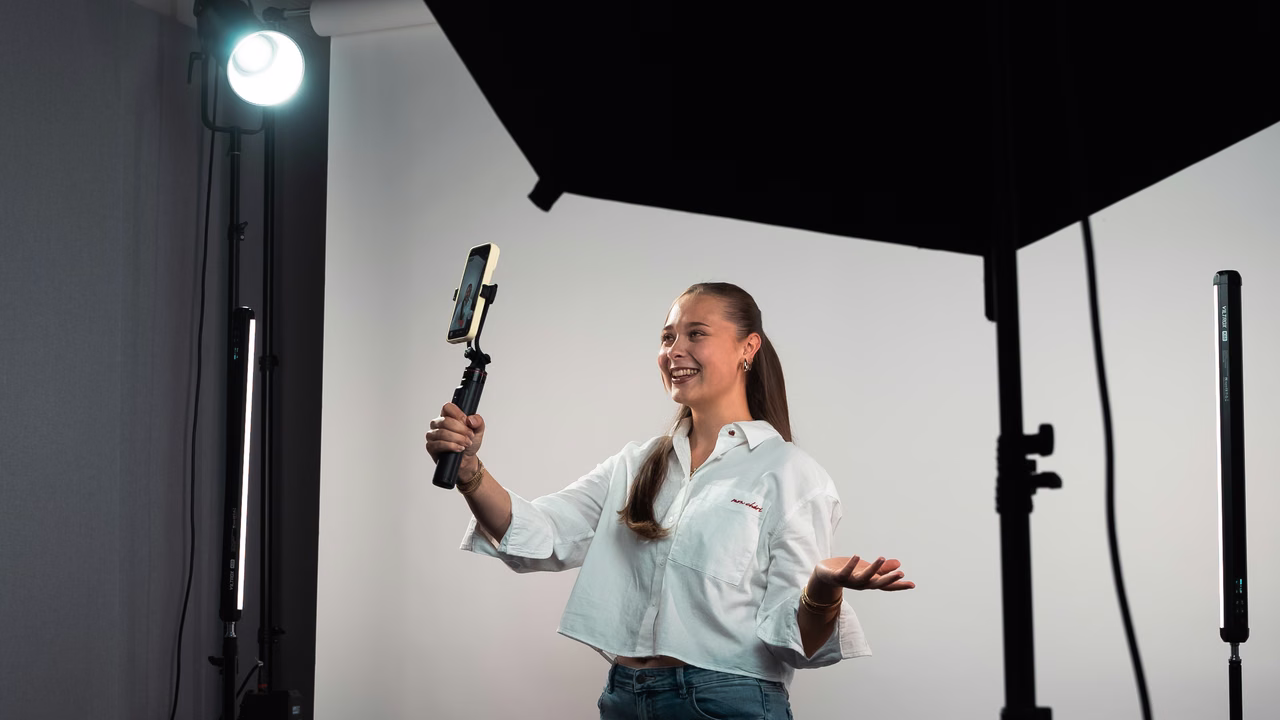 A creator filming to camera on a phone gimbal in Campfire's studio