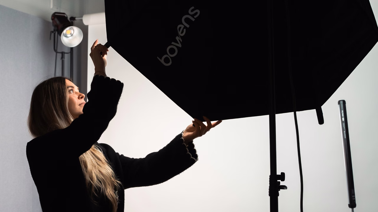 A Campfire team member setting up studio lighting for a shoot