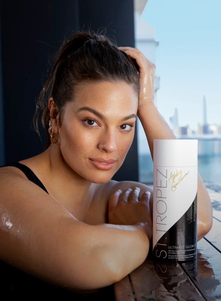 Ashley Graham with the St.Tropez Ultimate Glow Kit on a balcony overlooking the city
