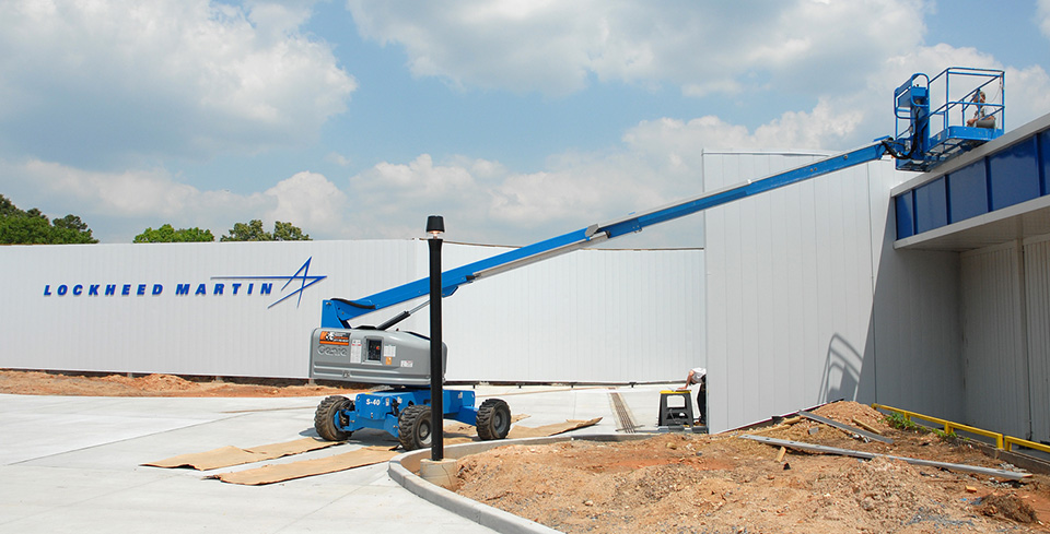 Boom lift beside a Lockheed Martin building under construction