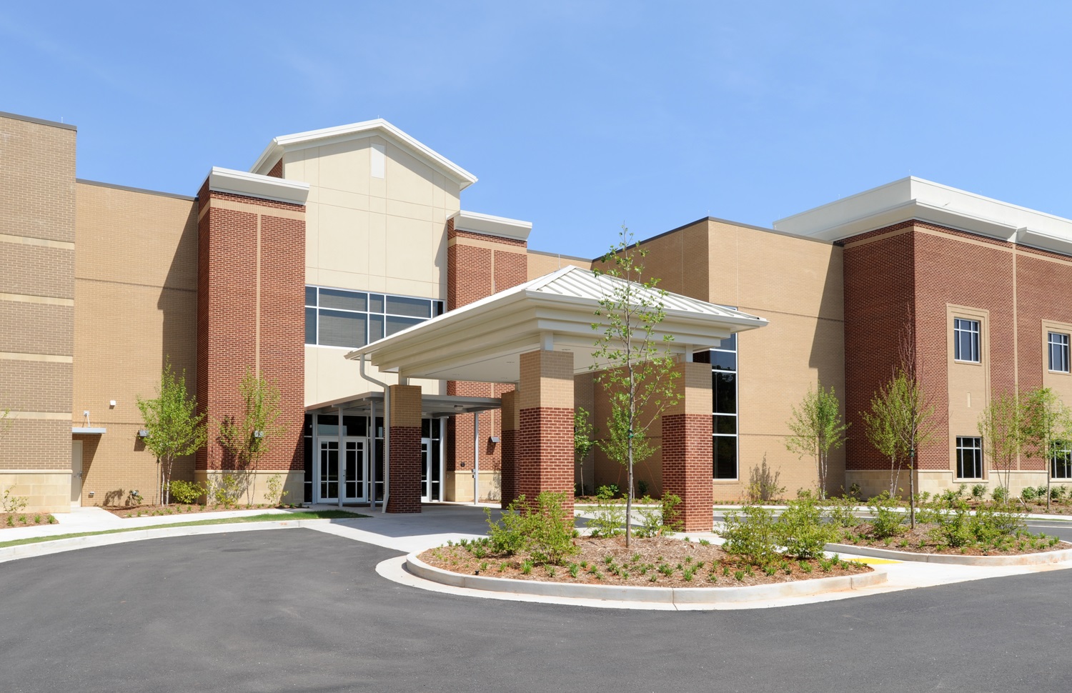 Brick and stucco entrance with covered porte-cochere at Prince Avenue Baptist Church Worship Center