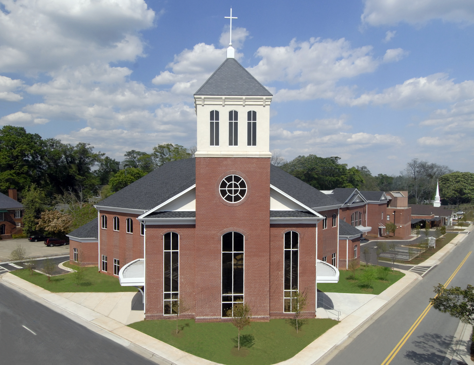 Zion Baptist Church Worship Center — red-brick church with a white cross-topped steeple tower