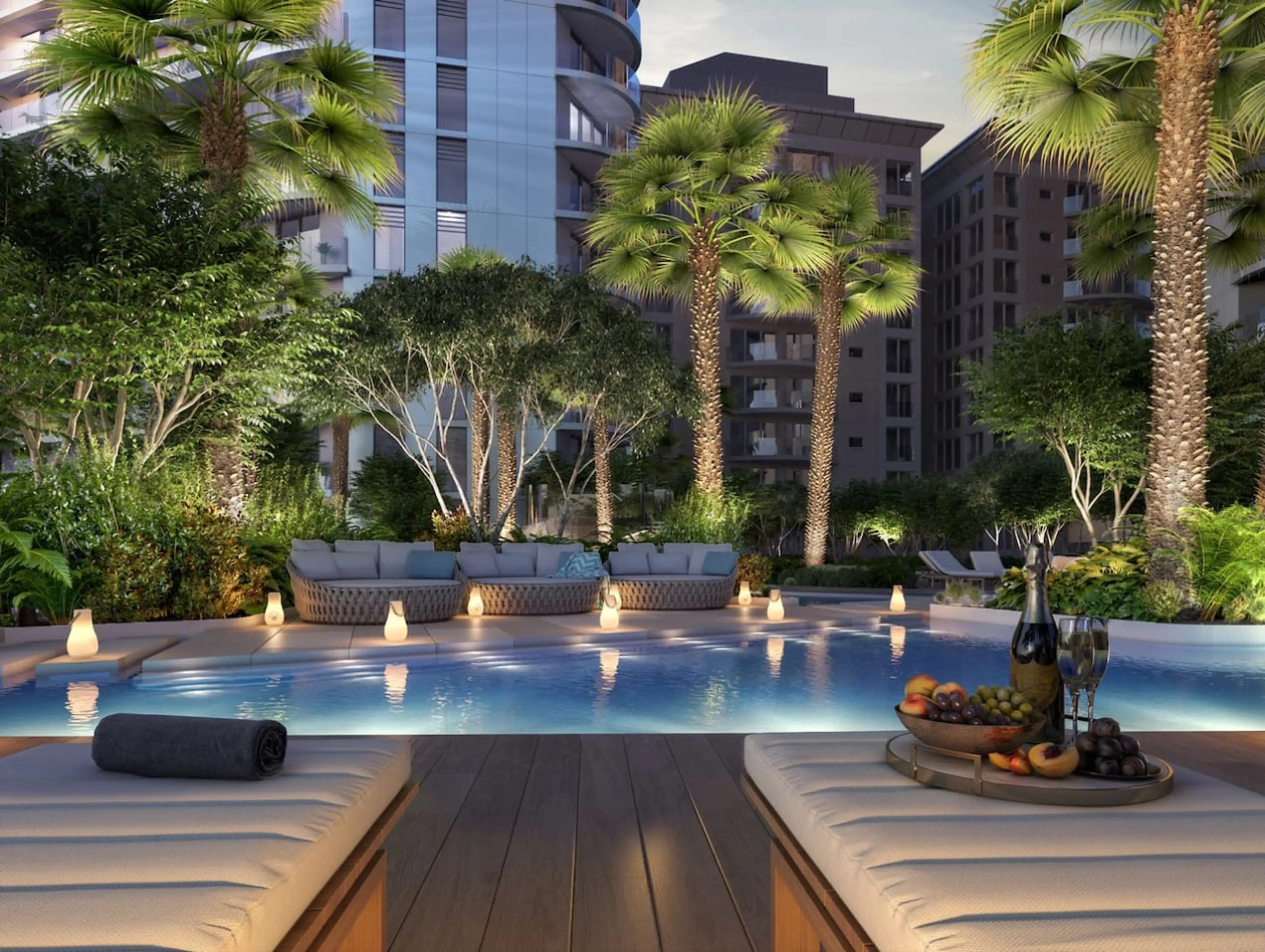 Evening by the pool at a Vista Ventures apartment block in Gibraltar, with palm trees, candlelit loungers and a fruit platter