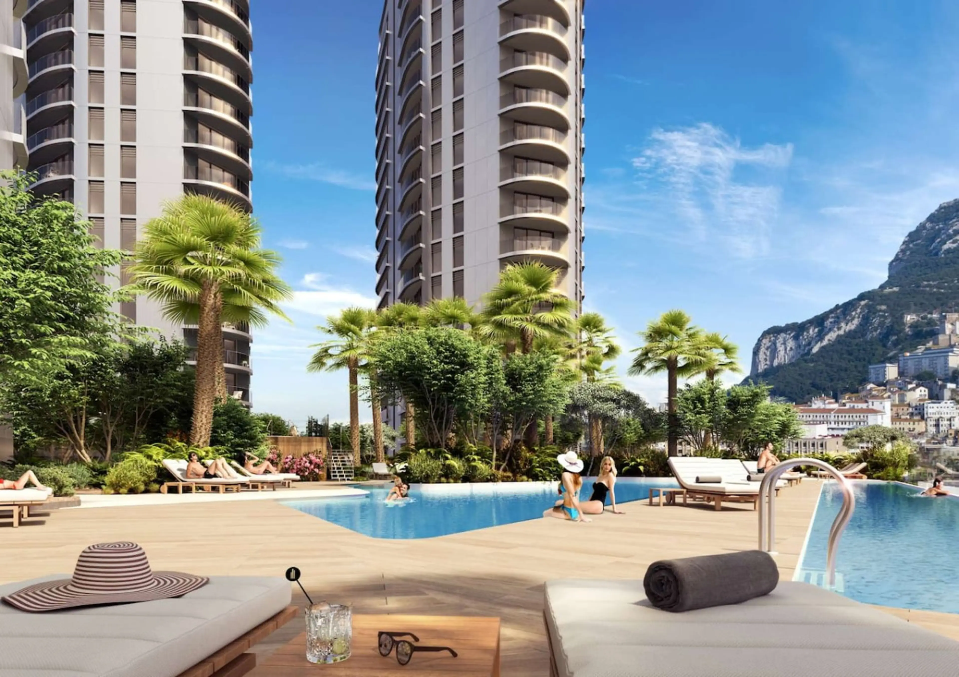 Eurocity pool terrace in Gibraltar, with sun loungers, palm trees and the Rock behind the towers