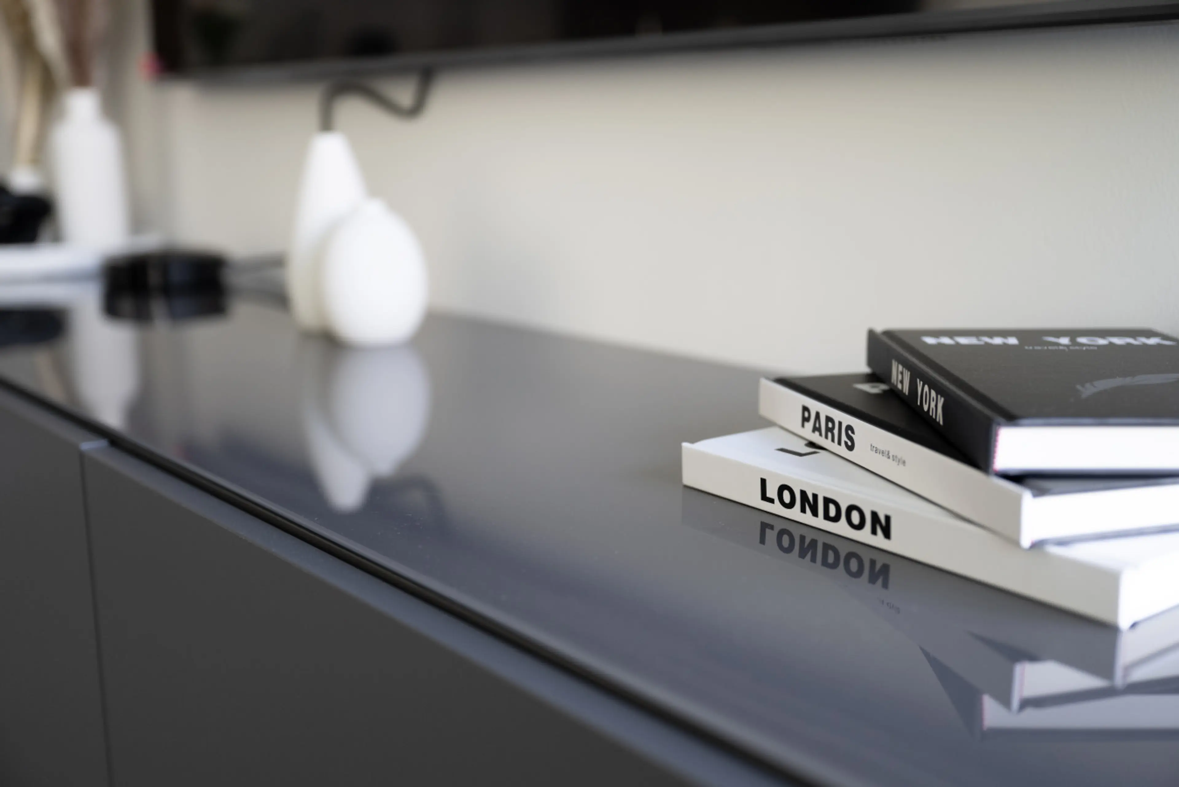 Travel books stacked on a kitchen counter in a Vista Ventures apartment