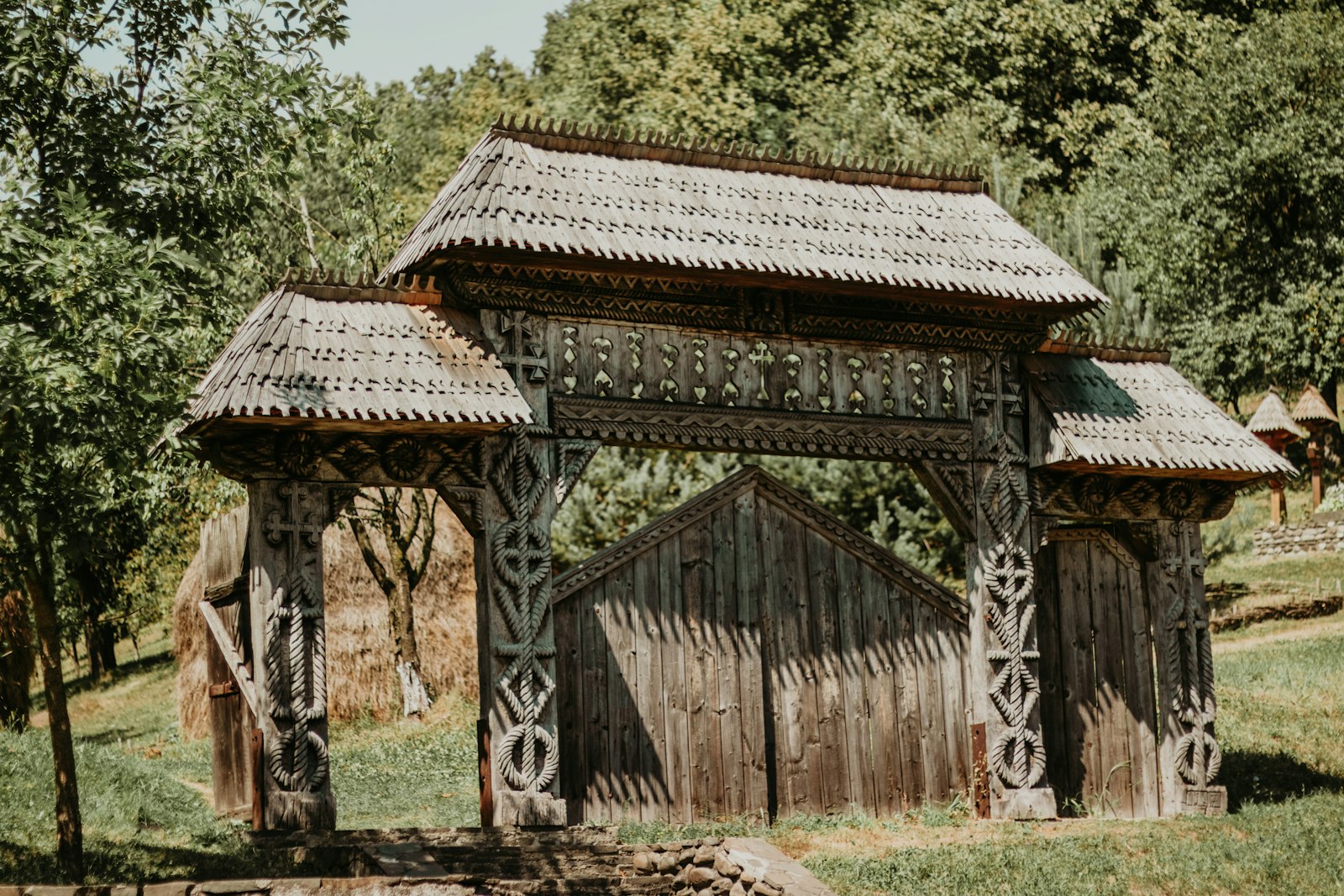 A traditional carved wooden gate at the entrance to a Maramures village