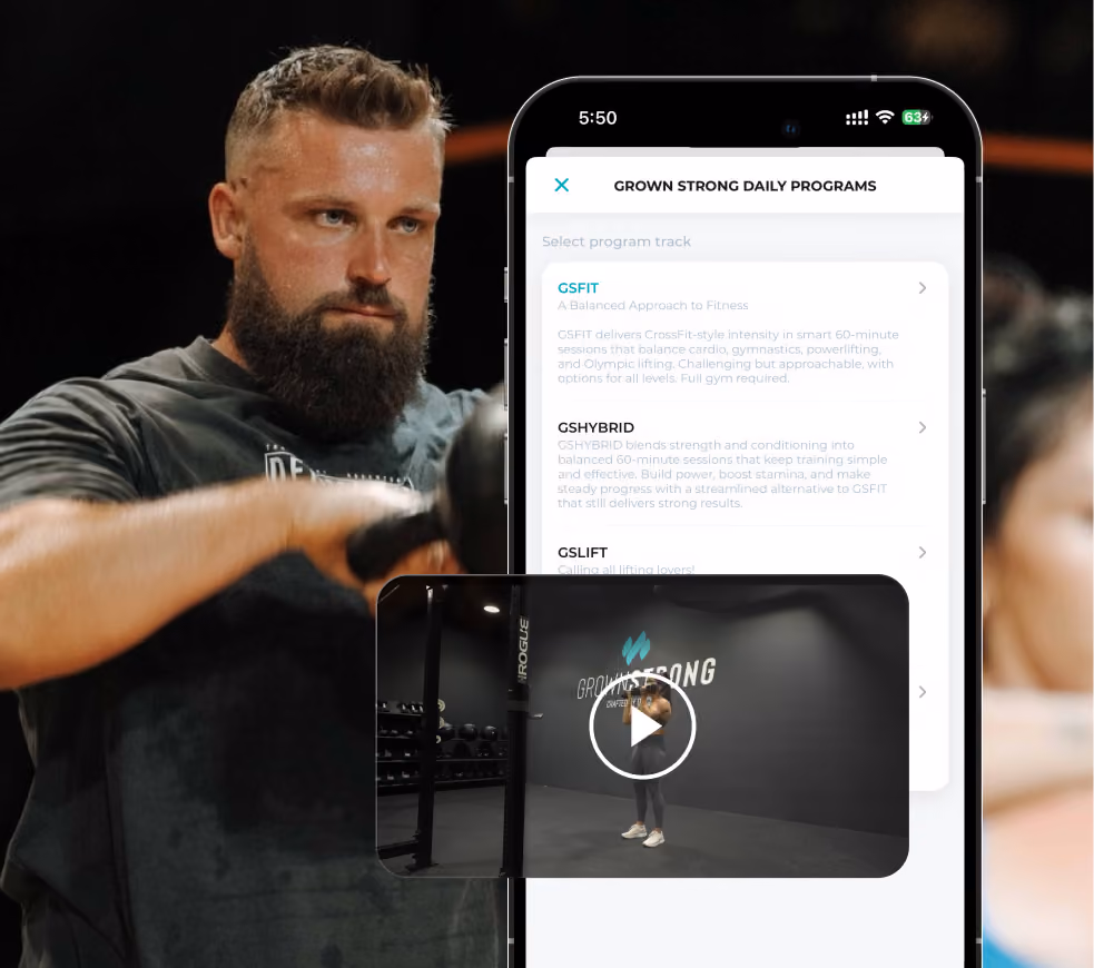 A man with a beard and dark t-shirt stands outdoors in front of a blurred background of people and blue sky, next to a smartphone screen showing the Grown Strong Daily Programs app with workout options and a small video preview of a fitness instructor in a gym.