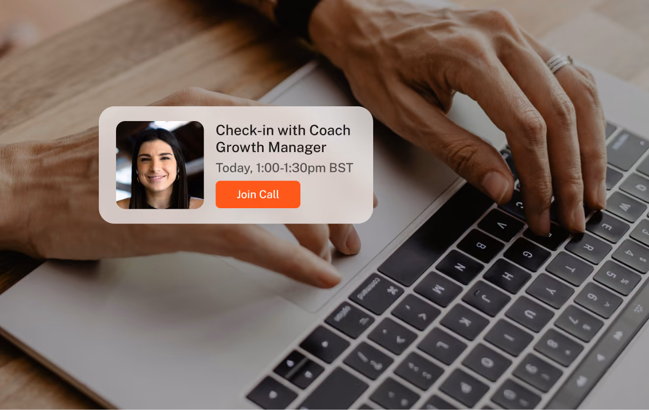 Hands typing on a laptop keyboard with a popup notification showing a video call invitation from Coach Growth Manager scheduled for today from 1:00 to 1:30pm BST, with a red 'Join Call' button and a small photo of a smiling woman.