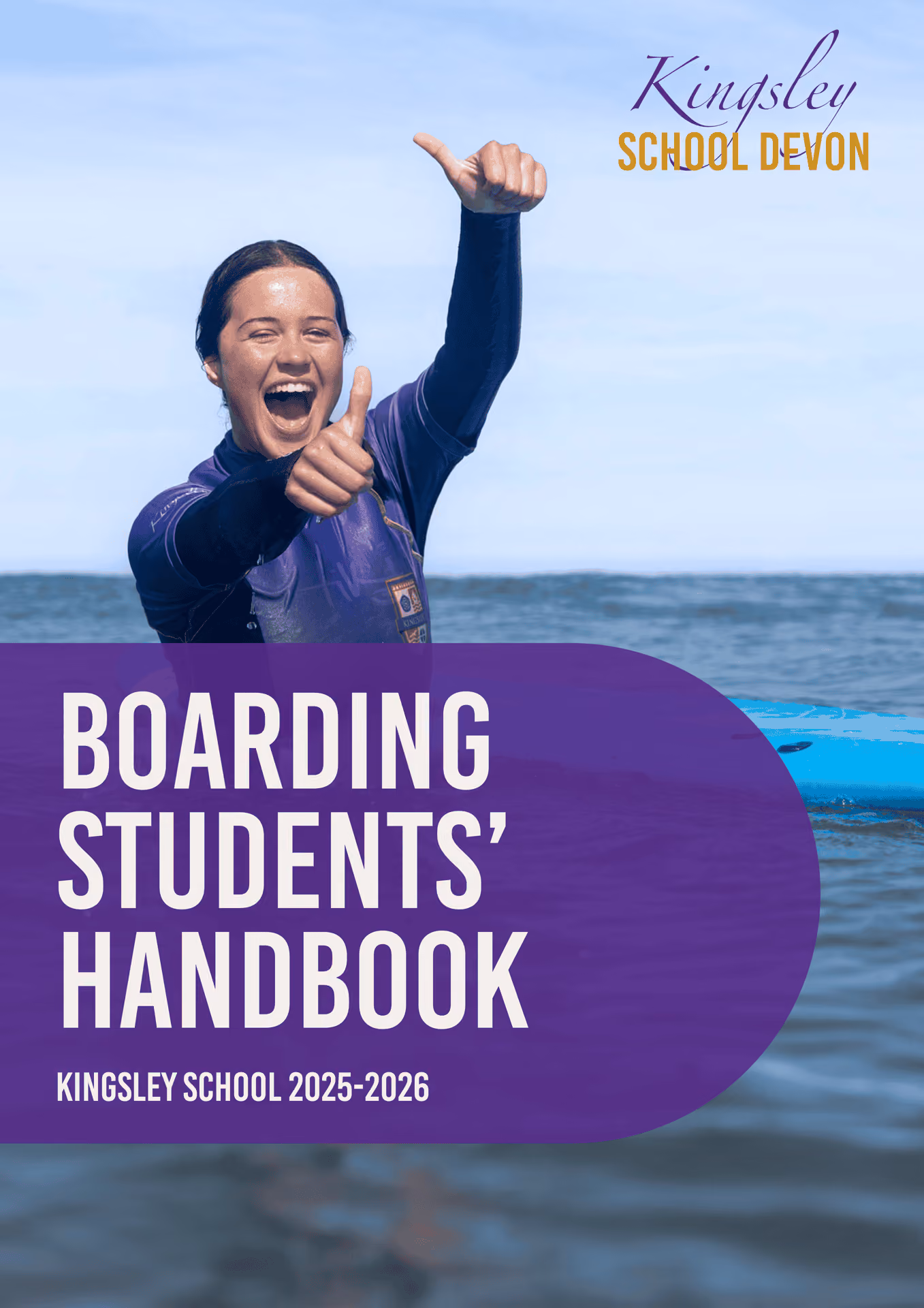 A young woman in a wetsuit giving two thumbs up while standing in the ocean next to a blue surfboard, with text overlay stating 'Boarding Students' Handbook Kingsley School 2025-2026' and Kingsley School Devon logo at the top right.