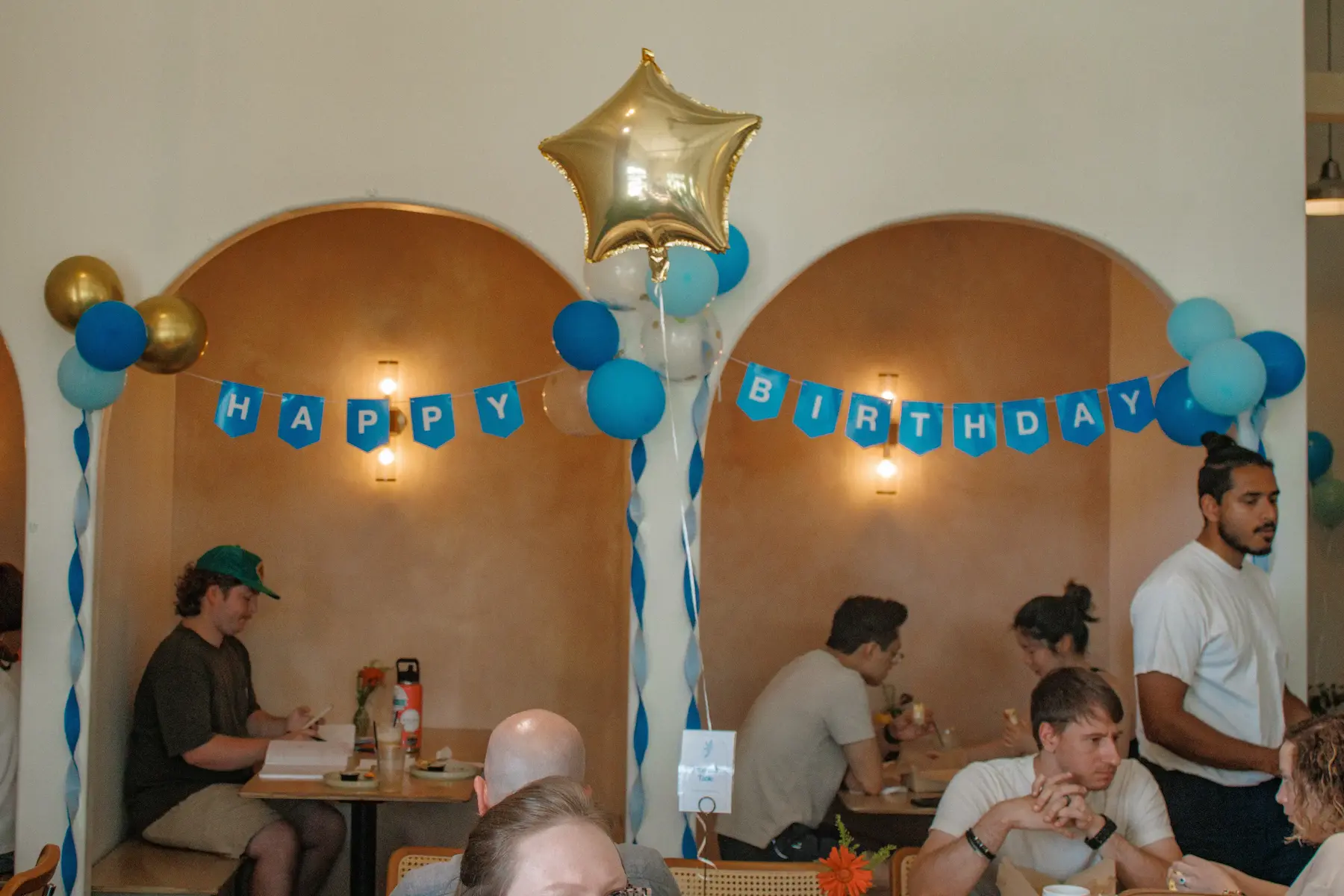 Guests celebrating a birthday inside Onward Coffee