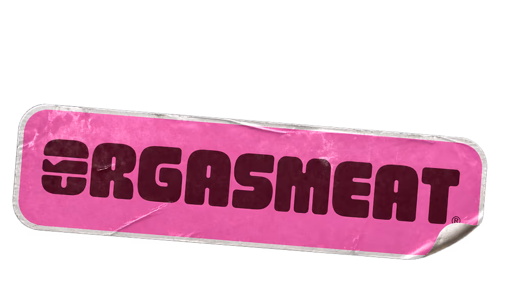 Pink rectangular sticker with the word 'ORGASMEAT' in bold, dark letters and a burger icon on the left.