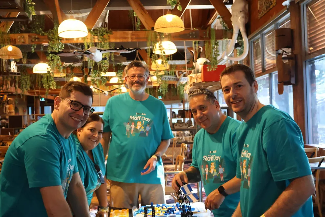 StrataMax team in matching shirts at a Surf Day team gathering