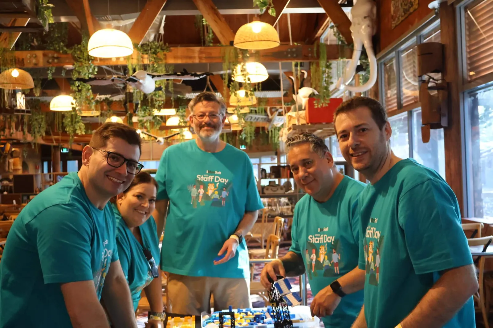 StrataMax team in matching shirts at a Surf Day team gathering