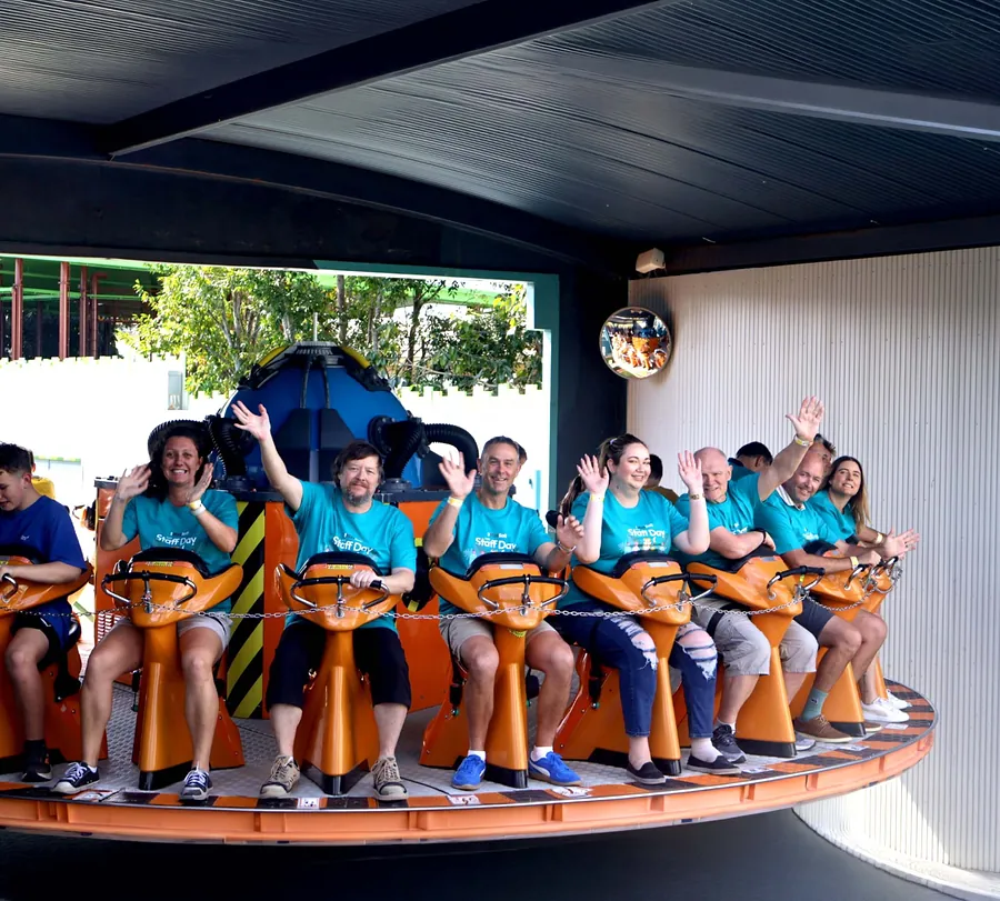StrataMax team riding a theme park attraction on a team day