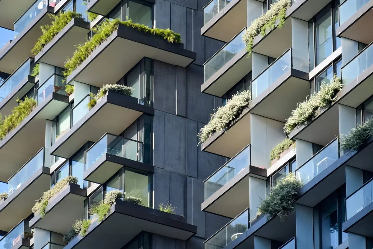 Apartment tower facade with greenery on every balcony