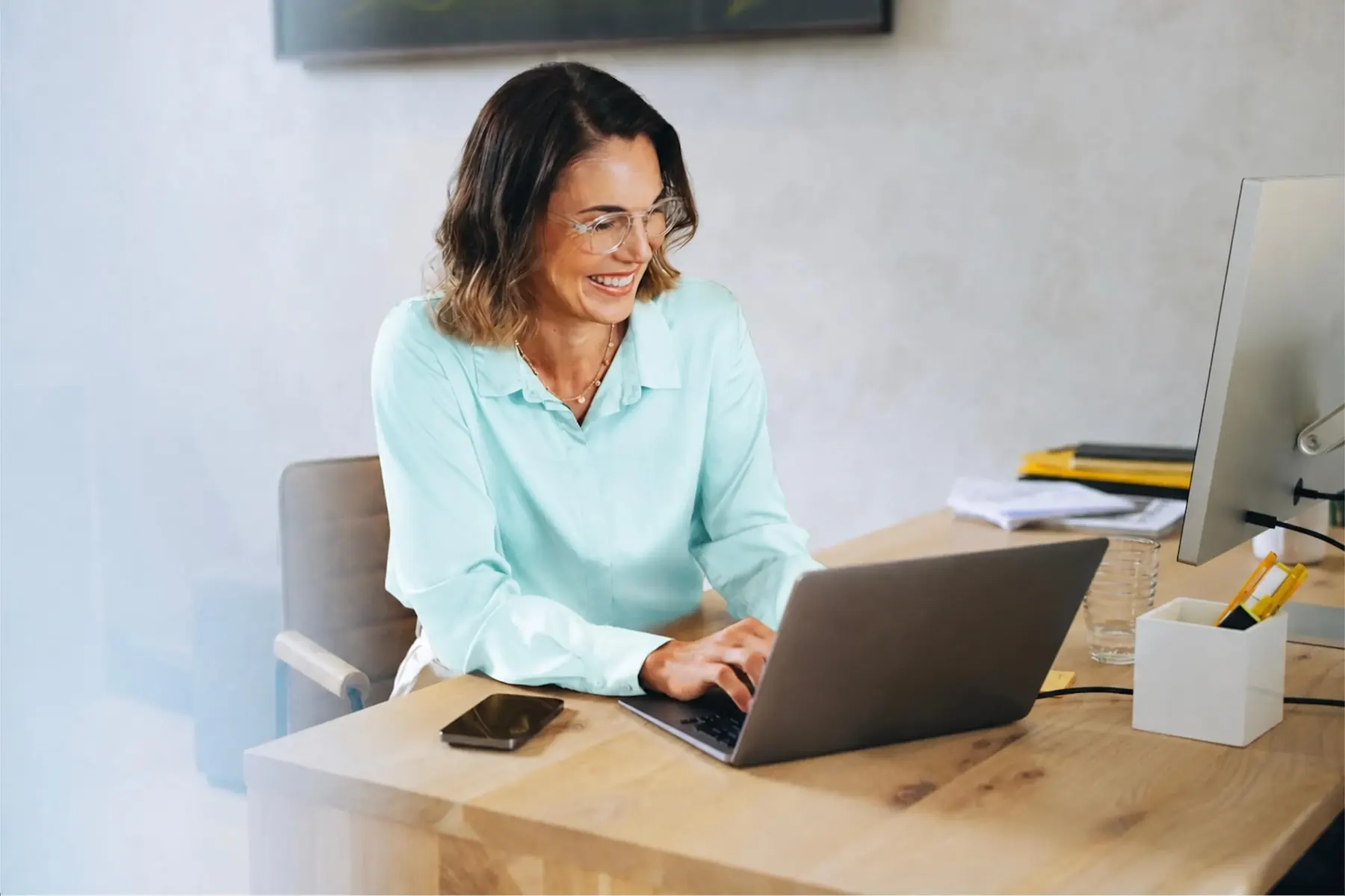 StrataMax support consultant working at a laptop