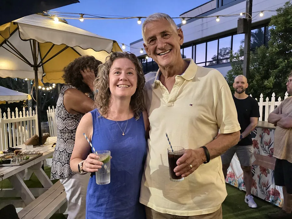 Two StrataMax team members at an outdoor evening event