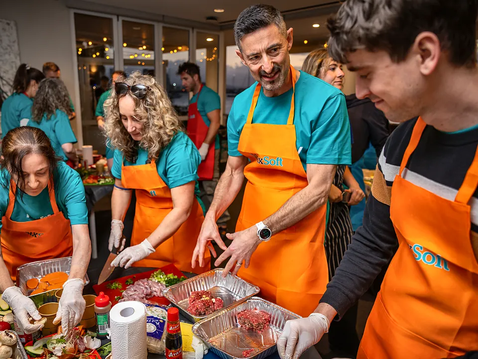 StrataMax team preparing food together at a team cooking challenge