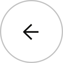 Left-pointing black arrow inside a gray circle.