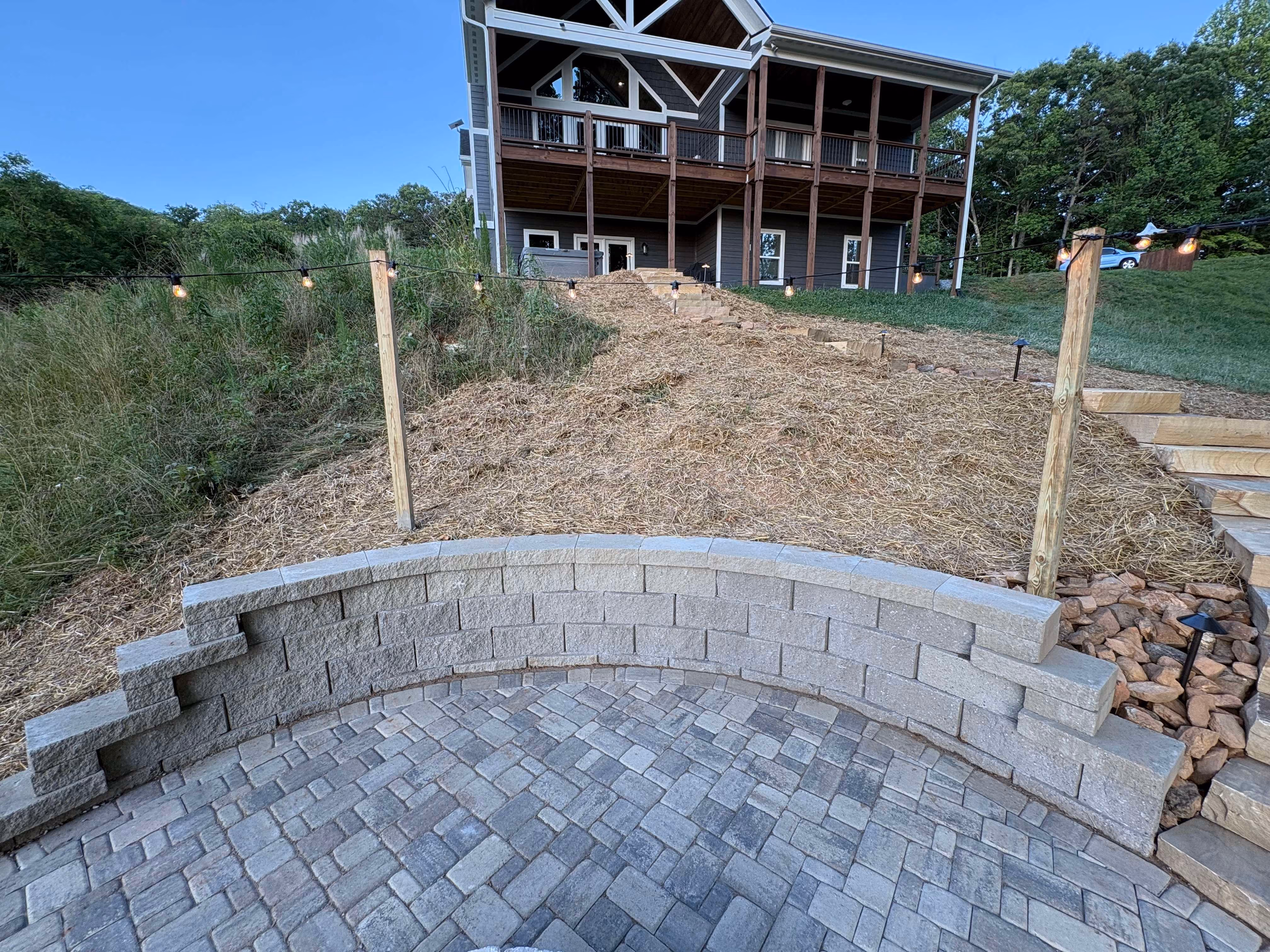 Custom outdoor living area and retaining wall by Rowland Outdoor Design
