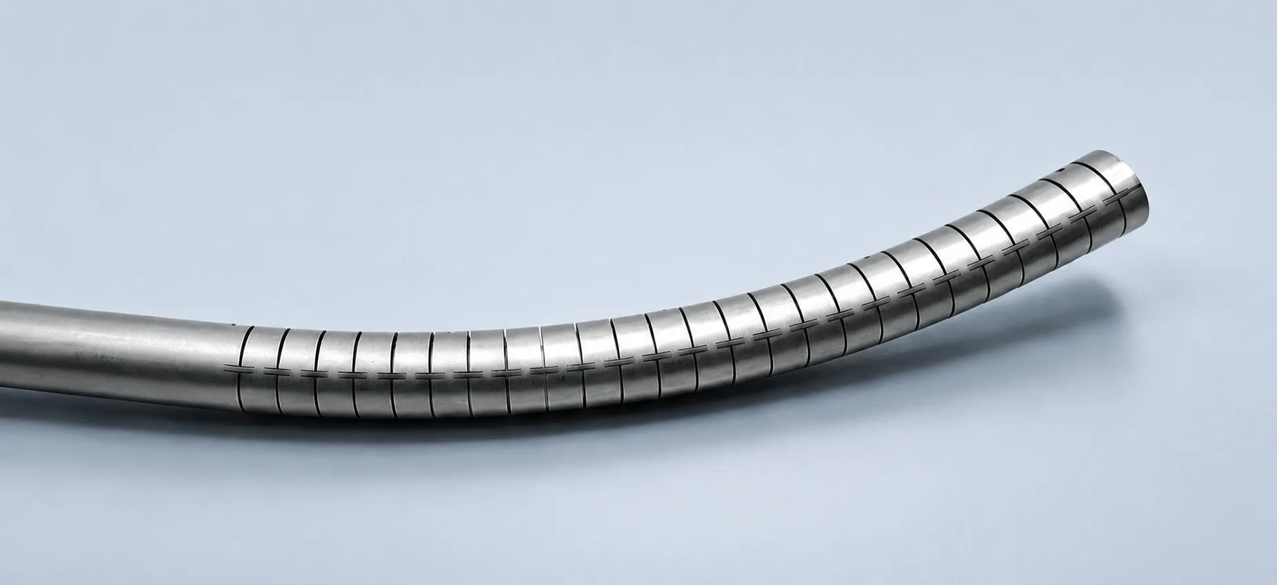 Laser-cut stainless steel hypotube with a spiral flexibility pattern, gently curved
