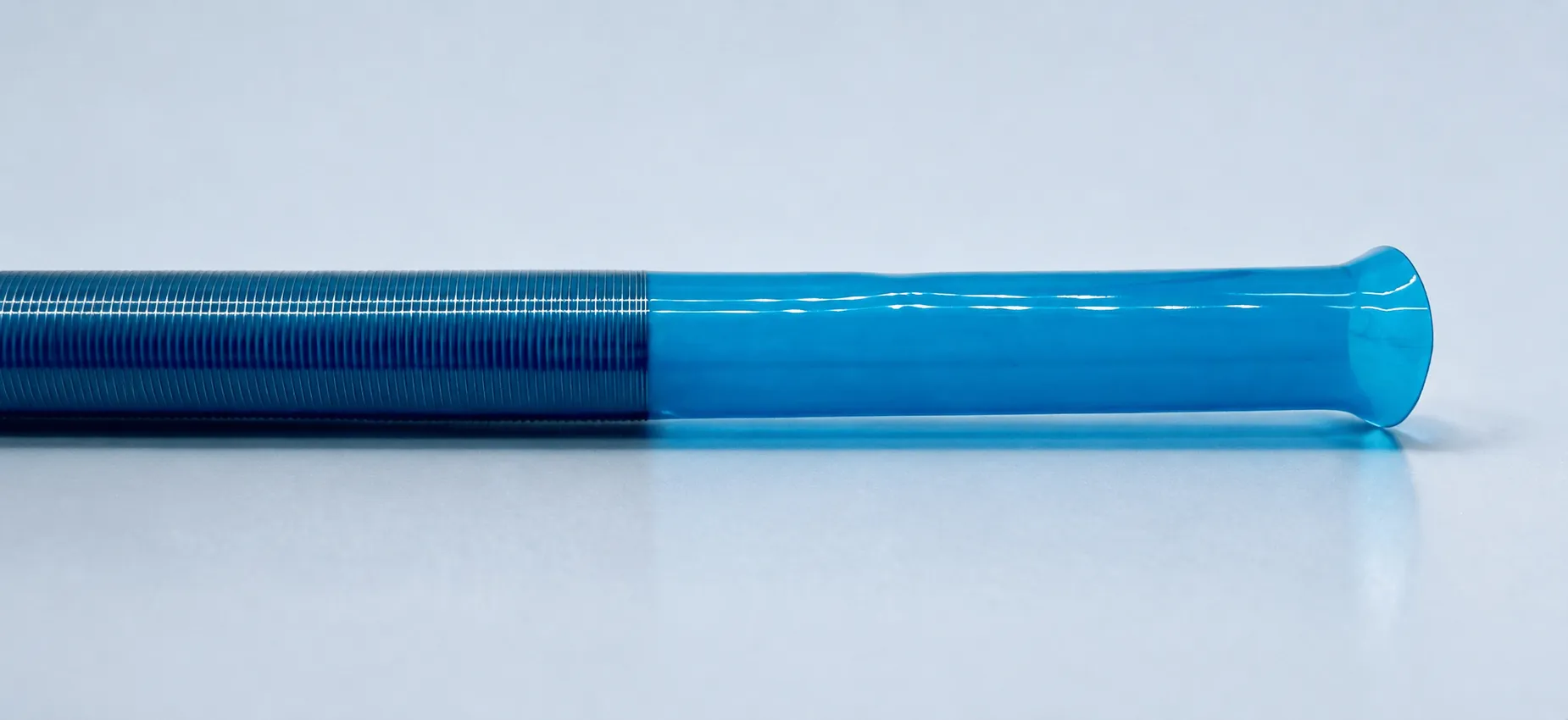 Blue catheter shaft with a coil-reinforced section and flared tip