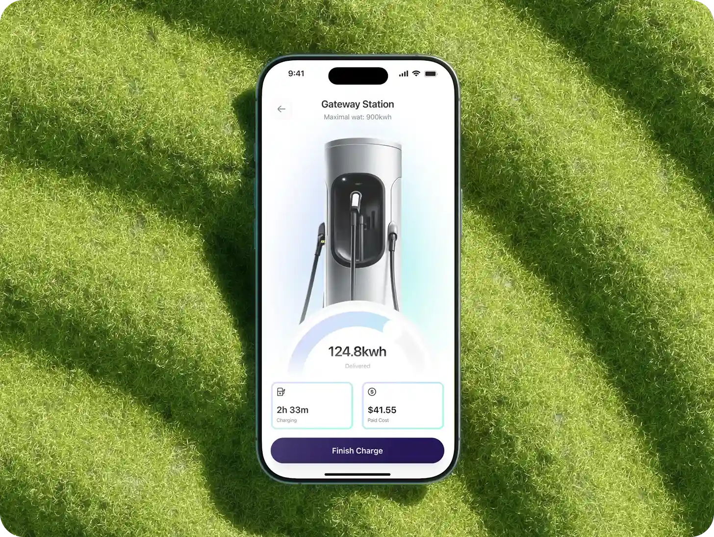Smartphone on grass showing EV charging app with 124.8 kWh delivered and $41.55 paid cost.