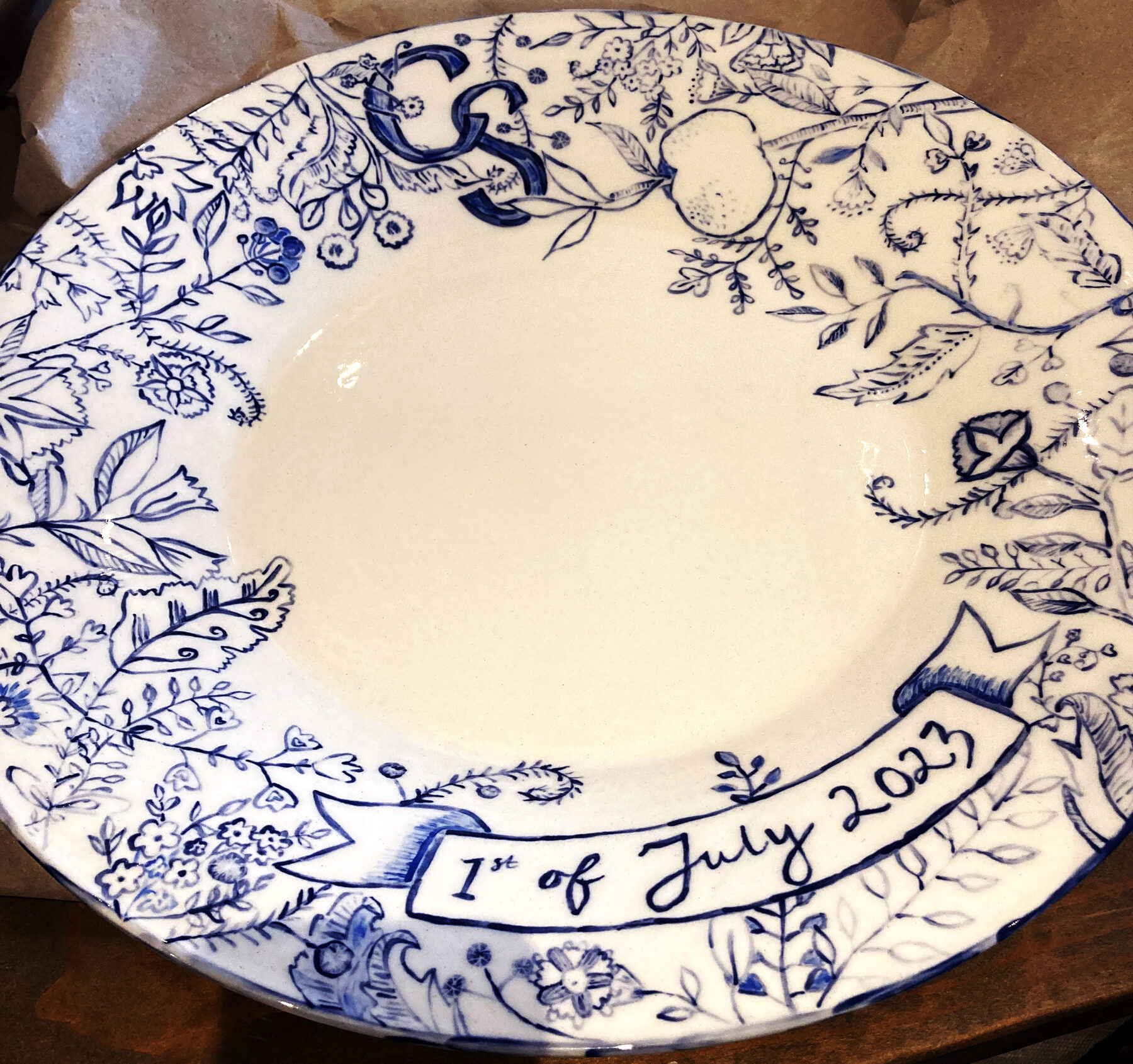 Hand-painted blue and white plate with CS monogram