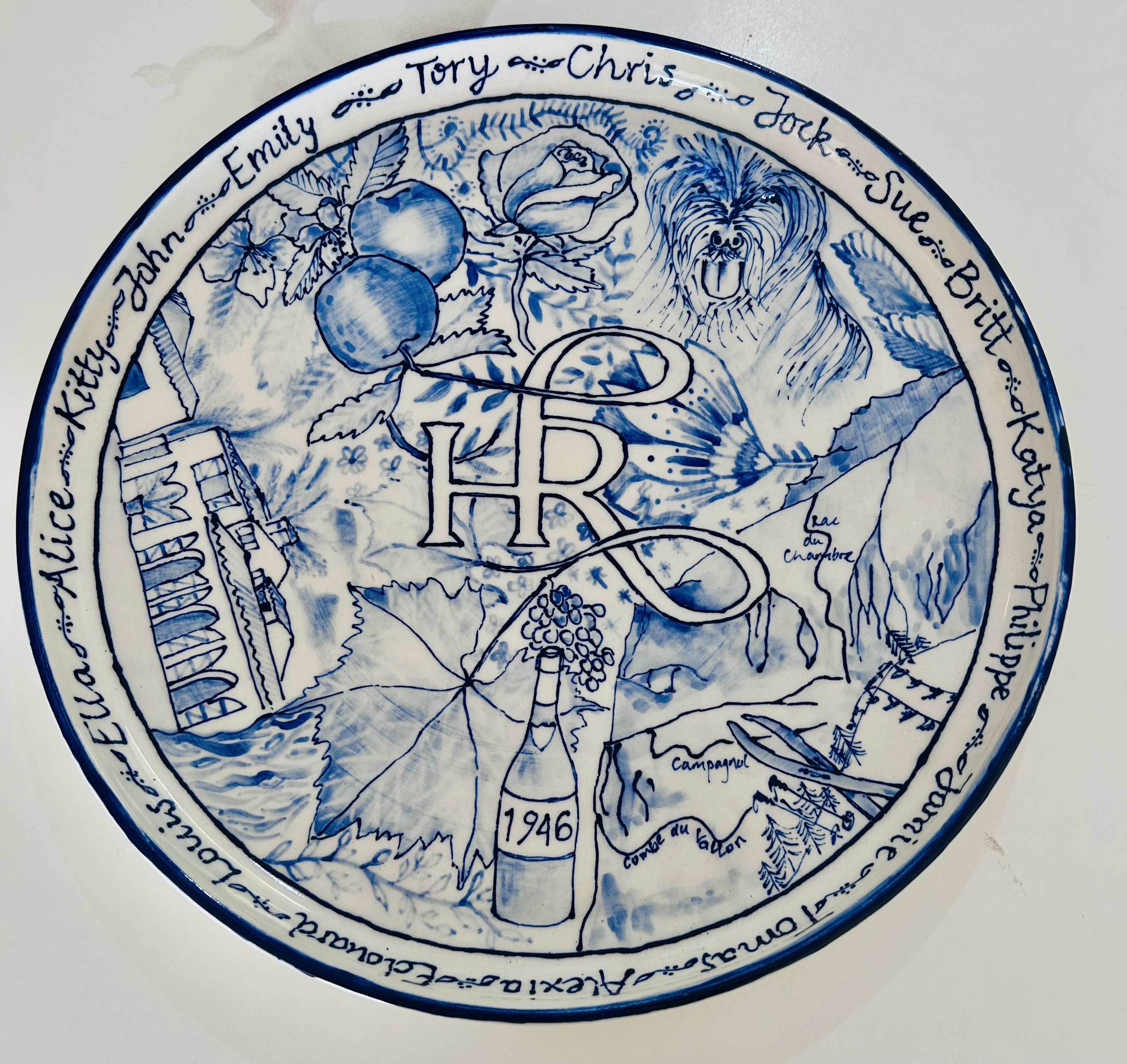 Hand-painted blue and white celebration plate with HR monogram
