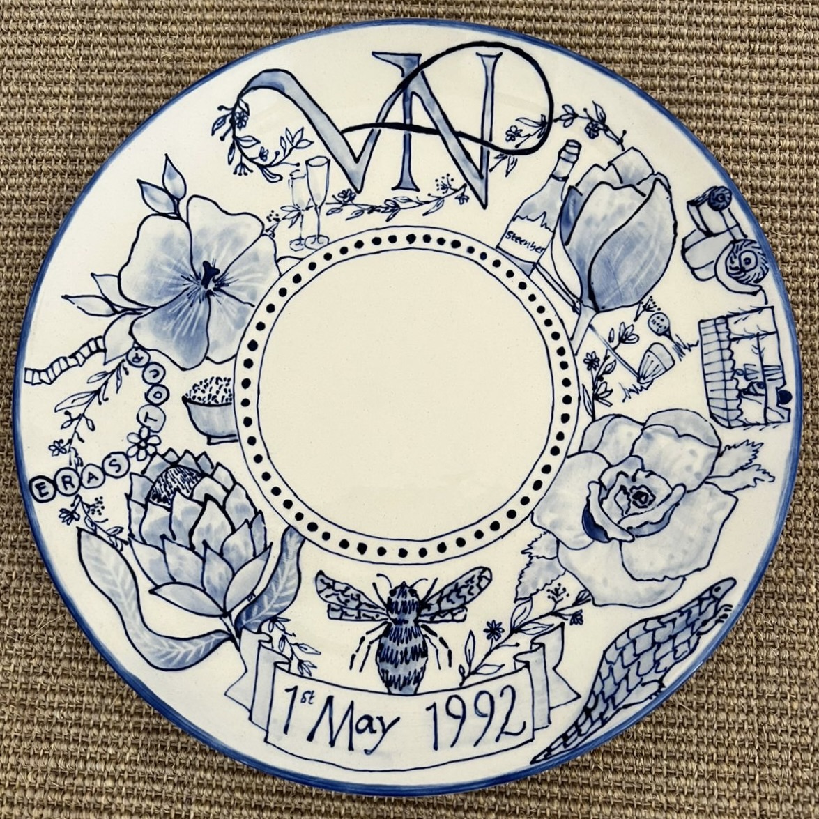 Hand-painted blue and white celebration plate with VN monogram