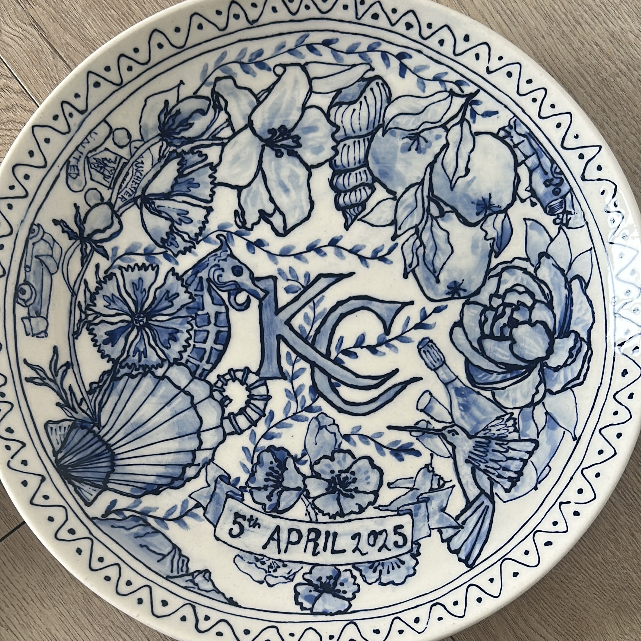 Hand-painted blue and white plate with seahorse and flowers