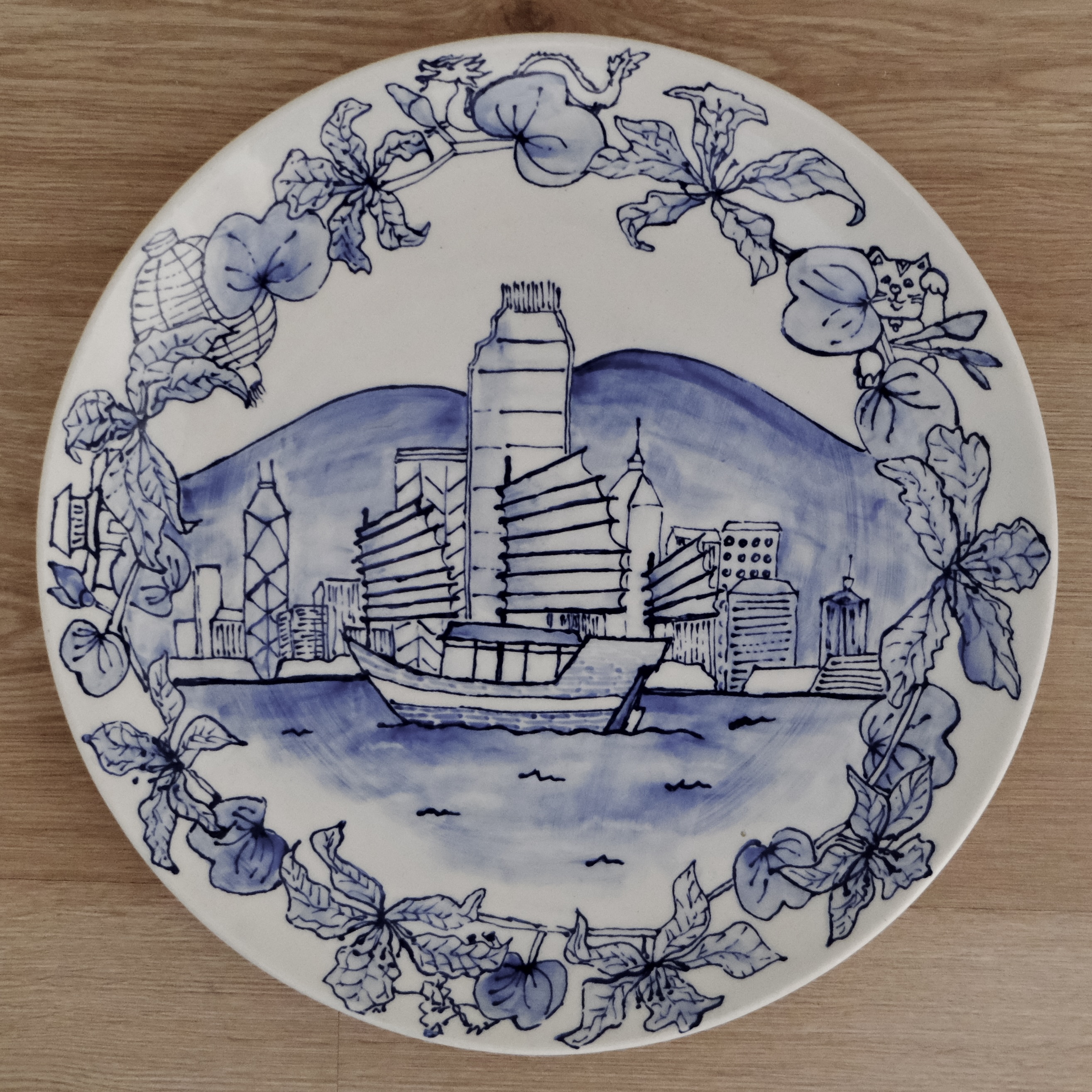 Hand-painted blue and white plate of Hong Kong harbour