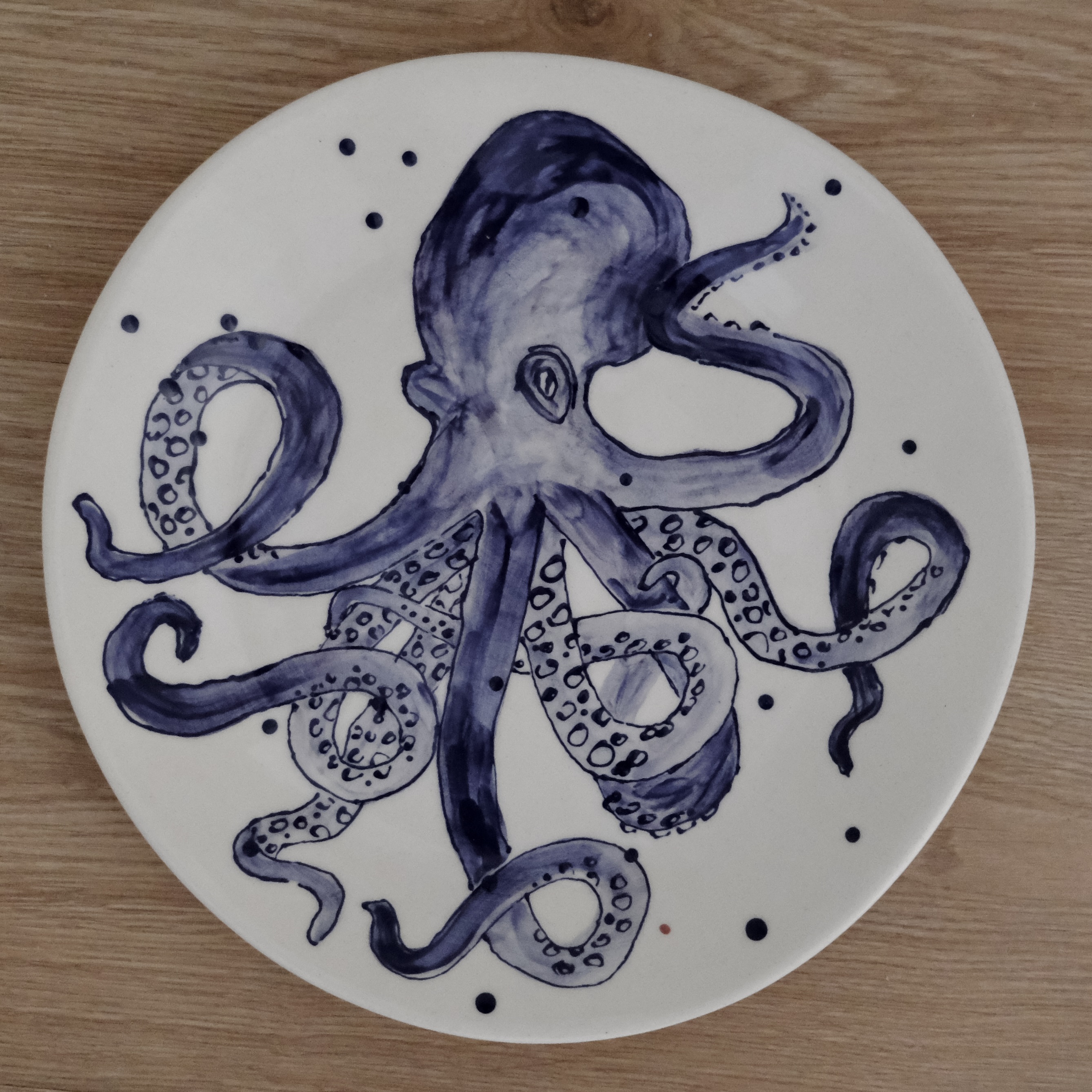 Hand-painted dinner plate with a purple octopus