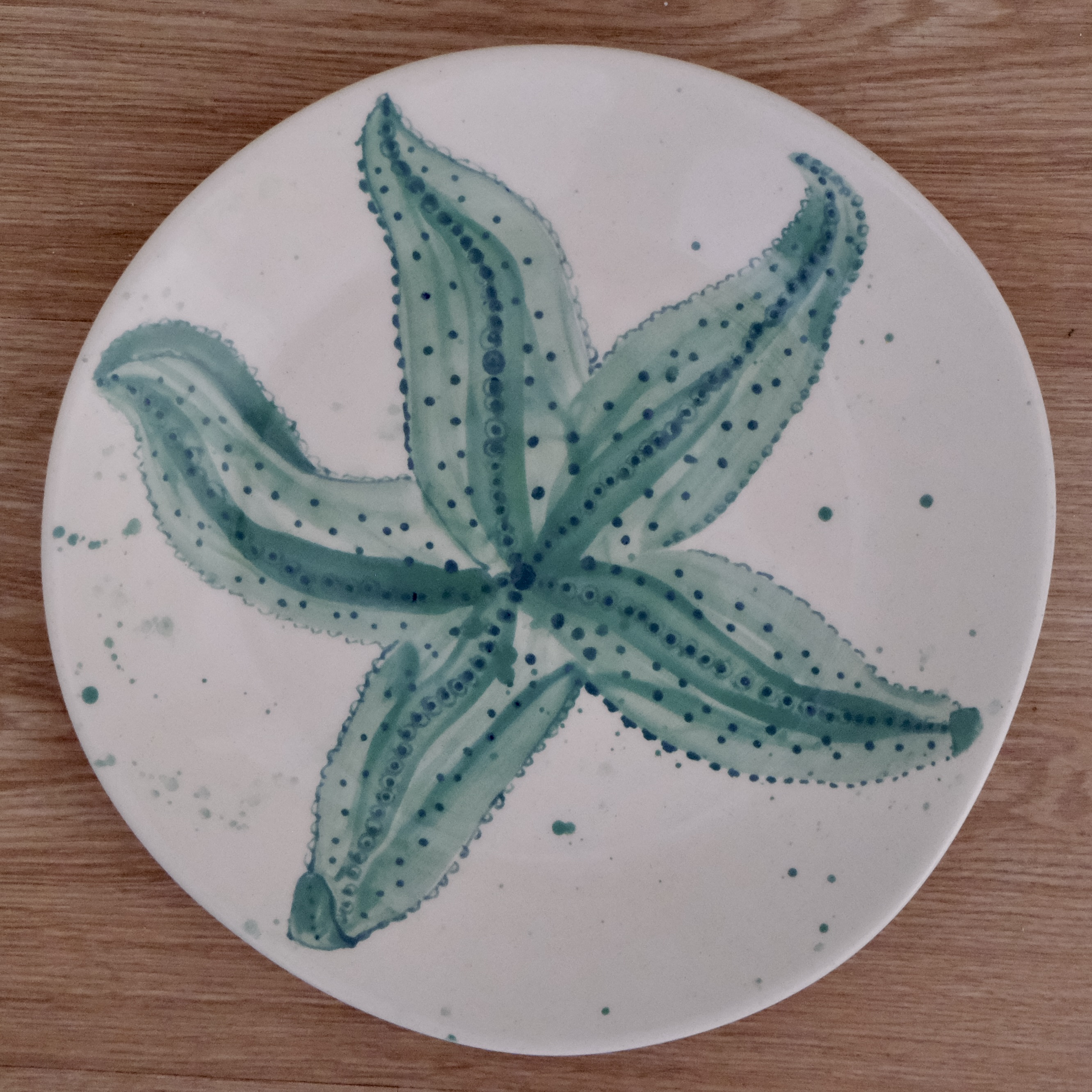 Hand-painted dinner plate with a green starfish
