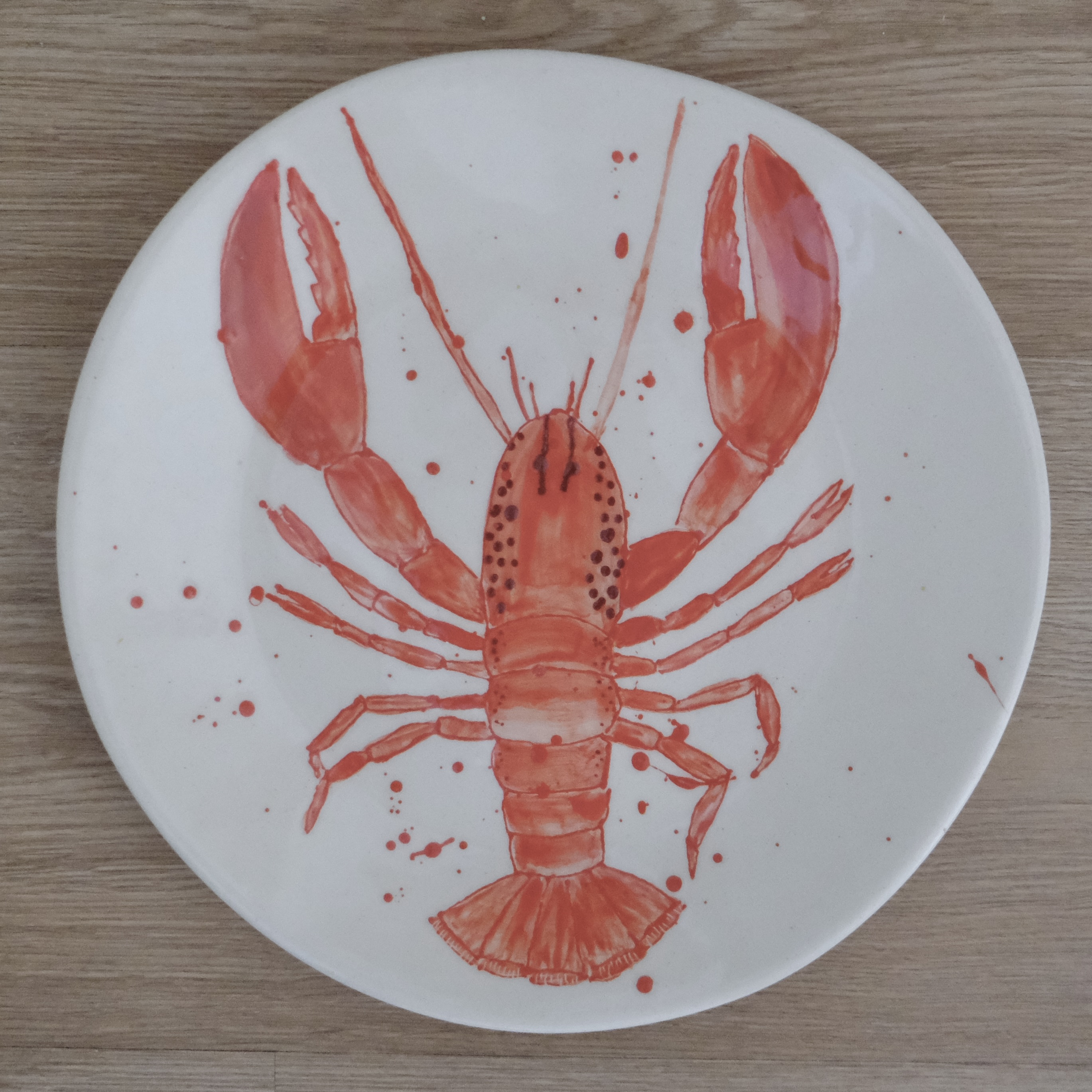 Hand-painted dinner plate with a red lobster