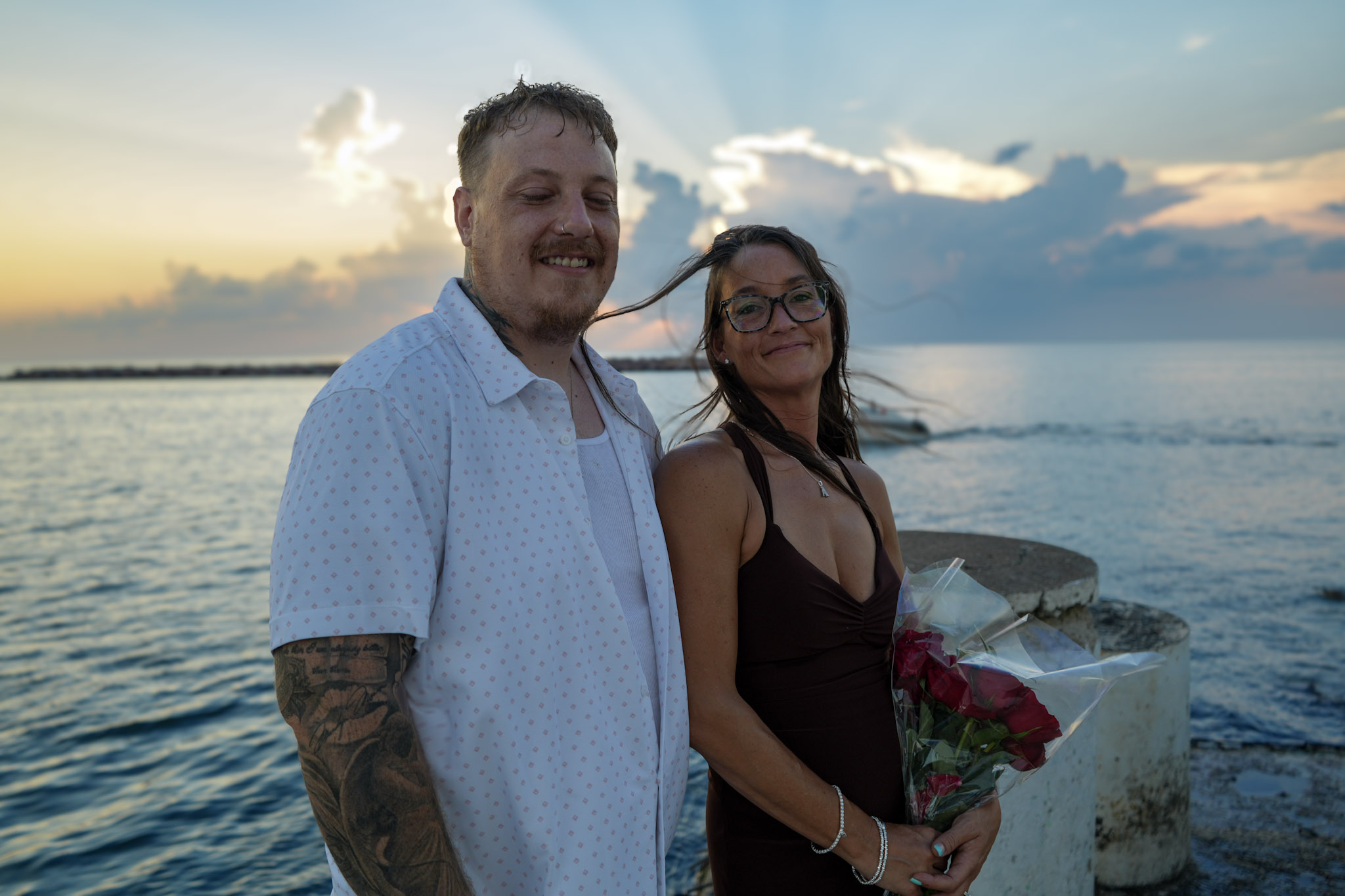 A couple sharing a moment together by the water.
