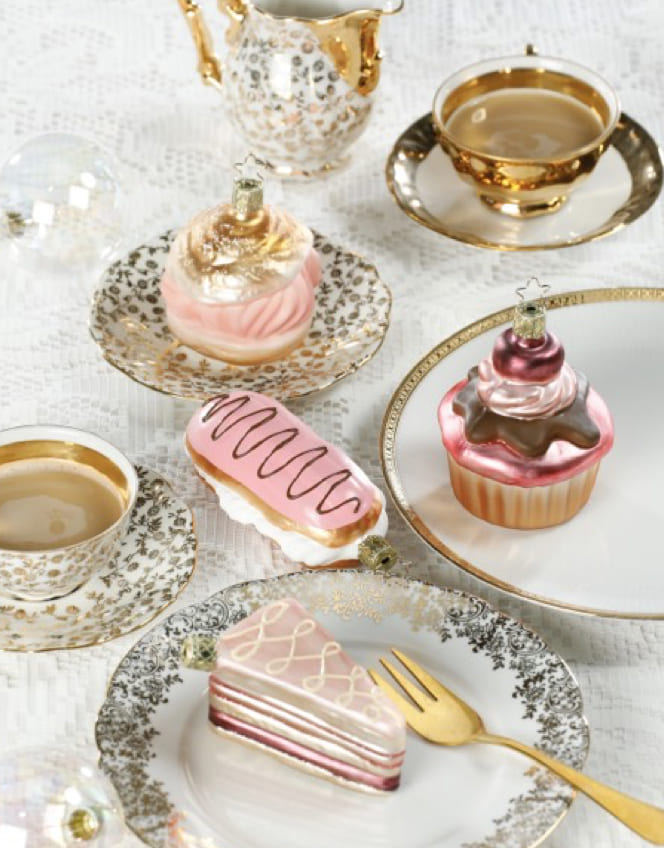 Glasornamente in Kuchen- und Gebäckform auf einer Kaffeetafel.