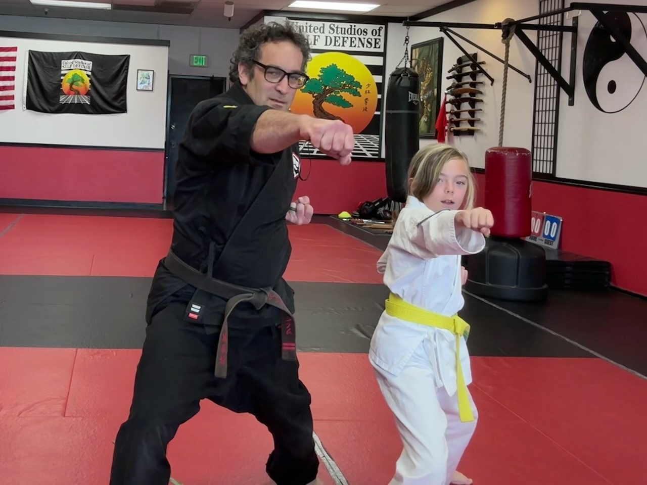 Yellow belt and instructor for Kids Karate Classes in Halfmoon Bay at United Studios of Self Defense
