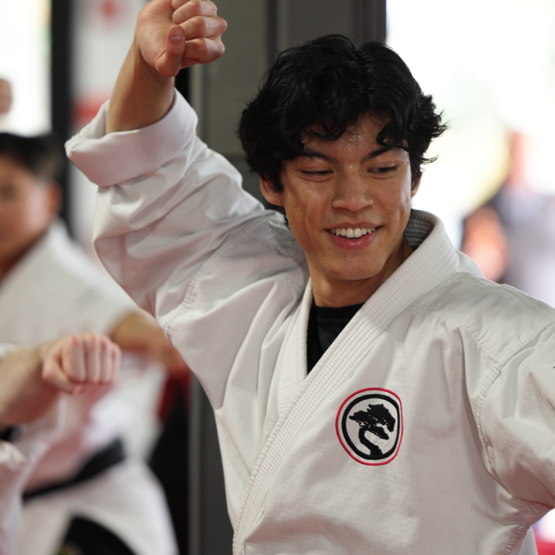 Adult Karate students training in the dojo.