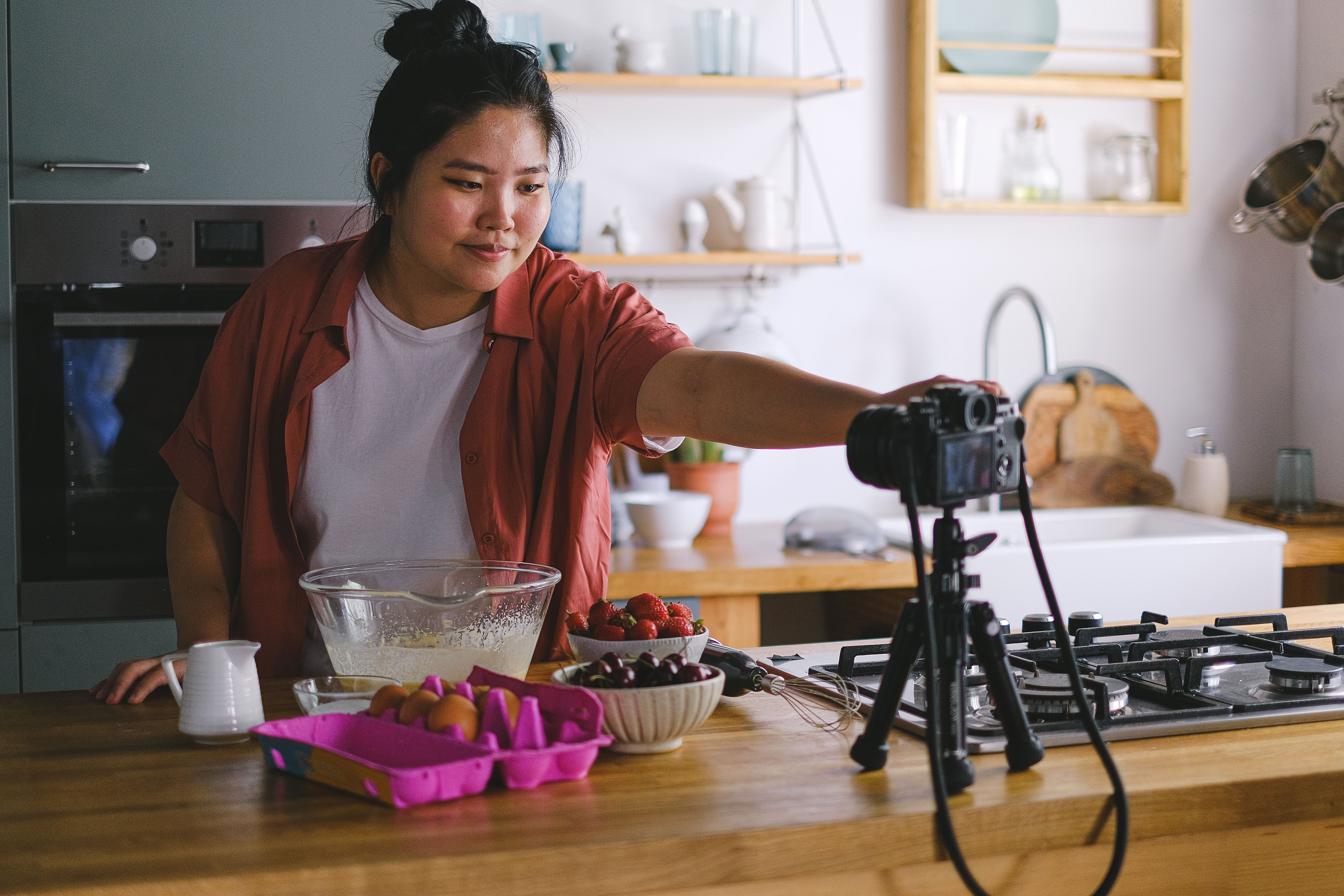 A content creator filming intentional, slower-paced video content on a camera and phone rig