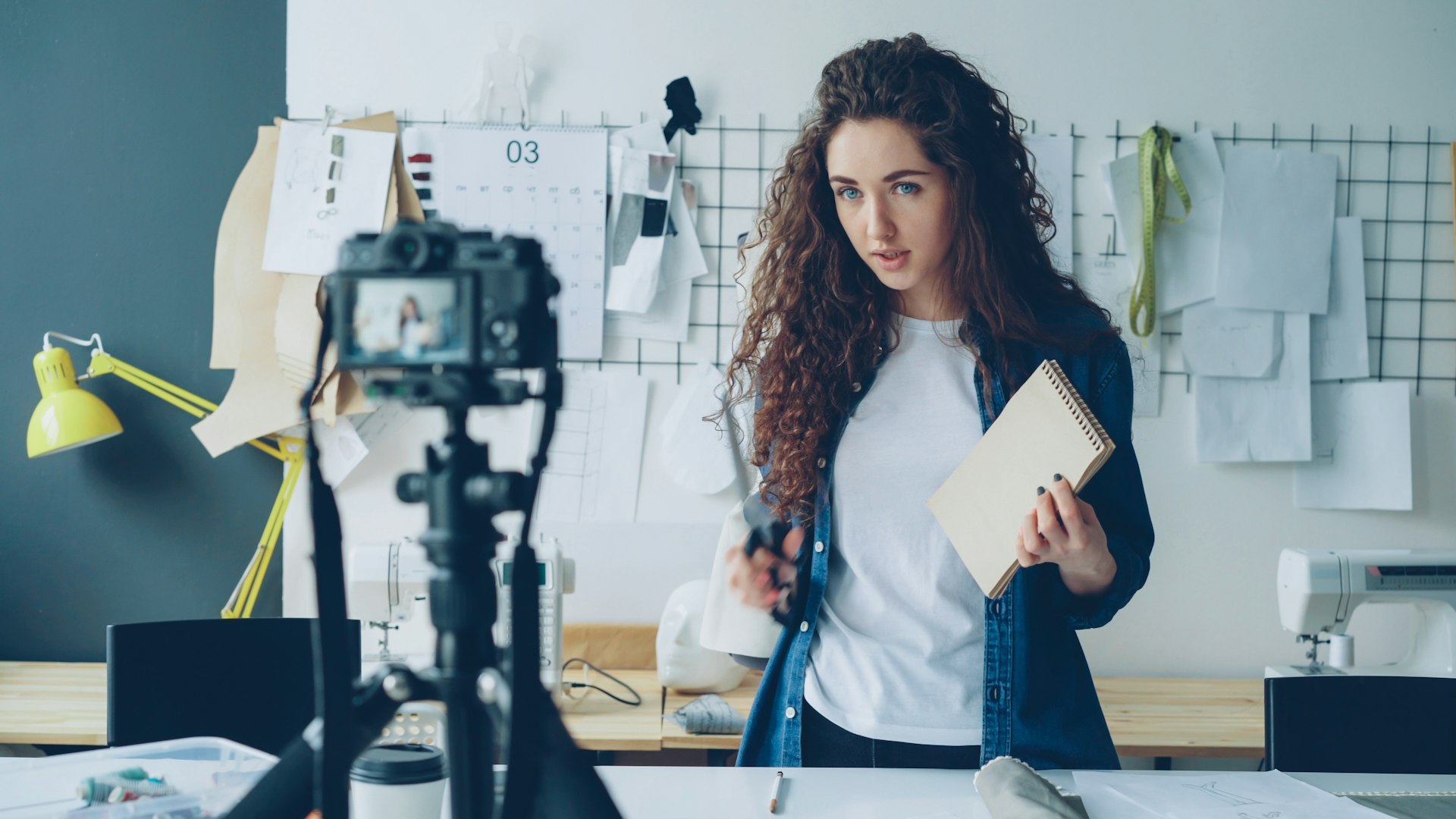 A small-business designer recording a video about her work, representing employee-generated content. Photo by Vitaly Gariev on Unsplash.