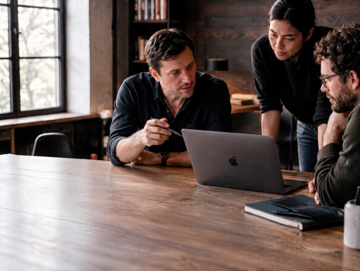 Three designers looking at a laptop
