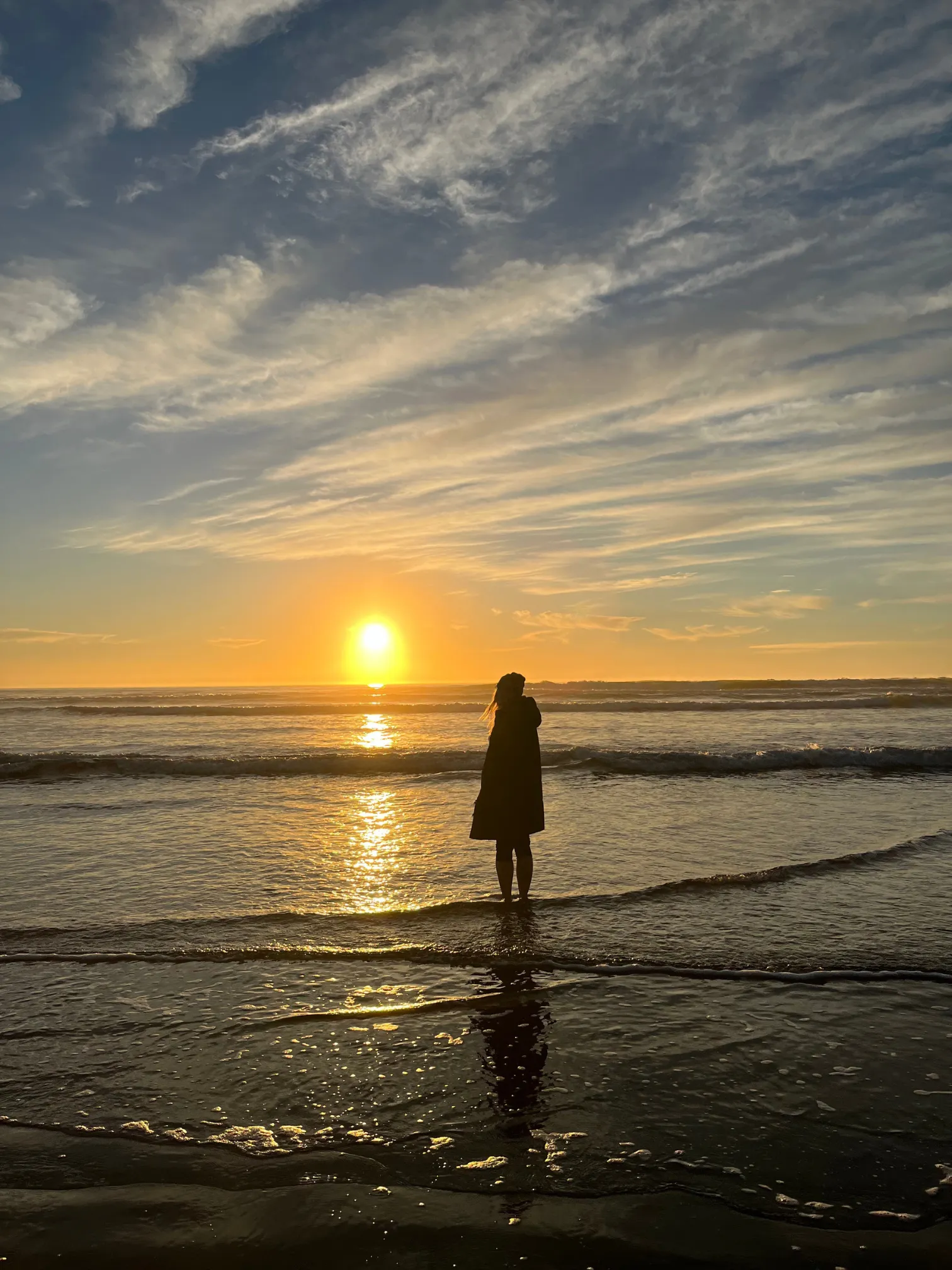a photograph of Kristin on the beach enjoying a sunset