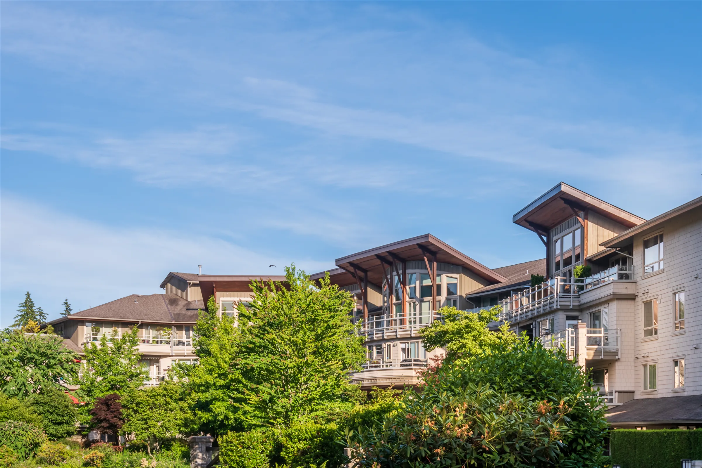 West Coast condominium buildings surrounded by trees in Greater Vancouver