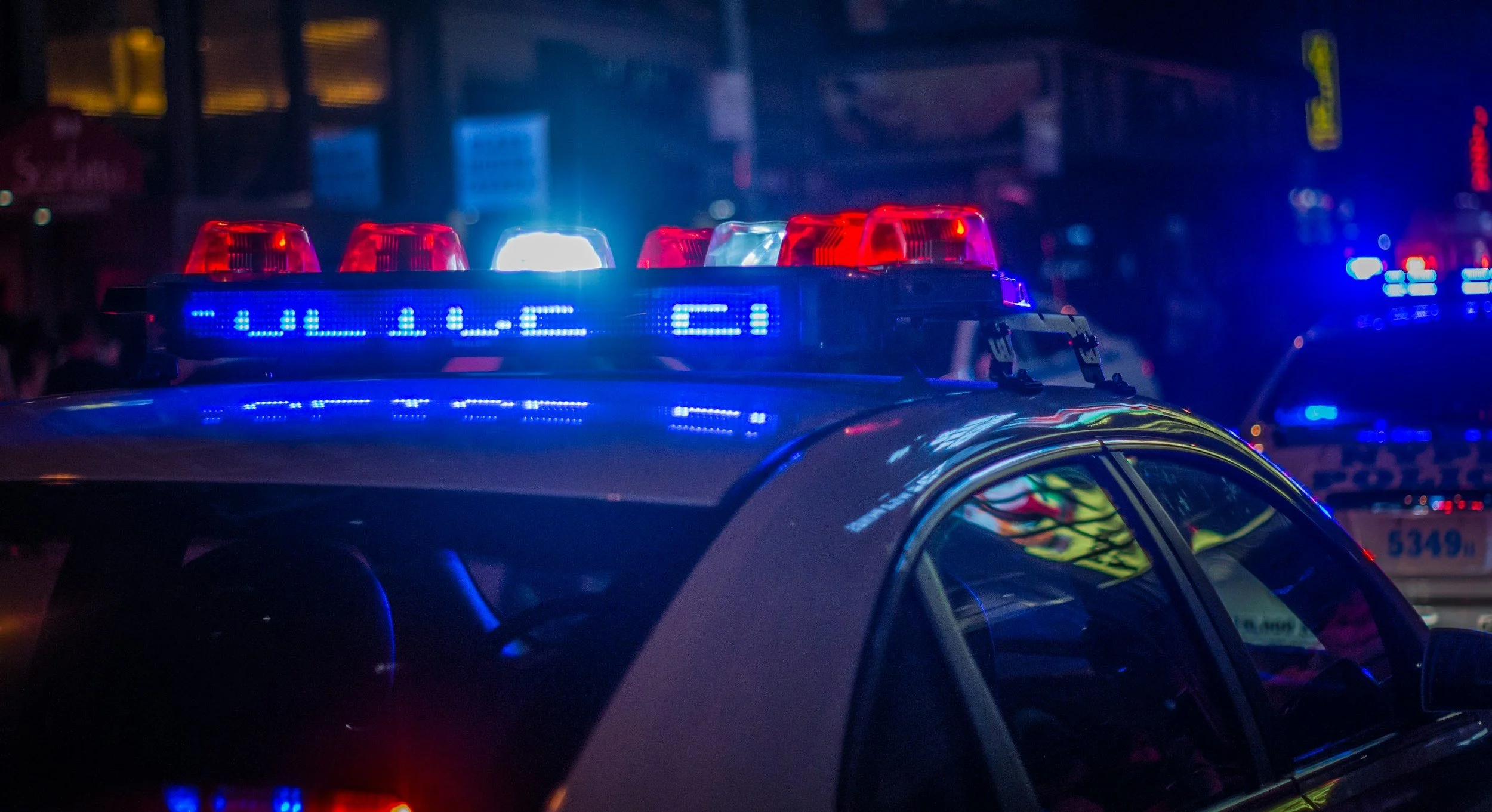 Police vehicles with emergency lights at night
