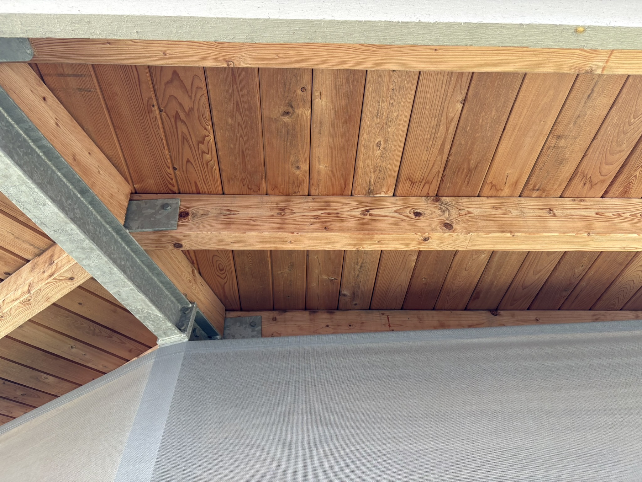 Faded architectural beams before restoration