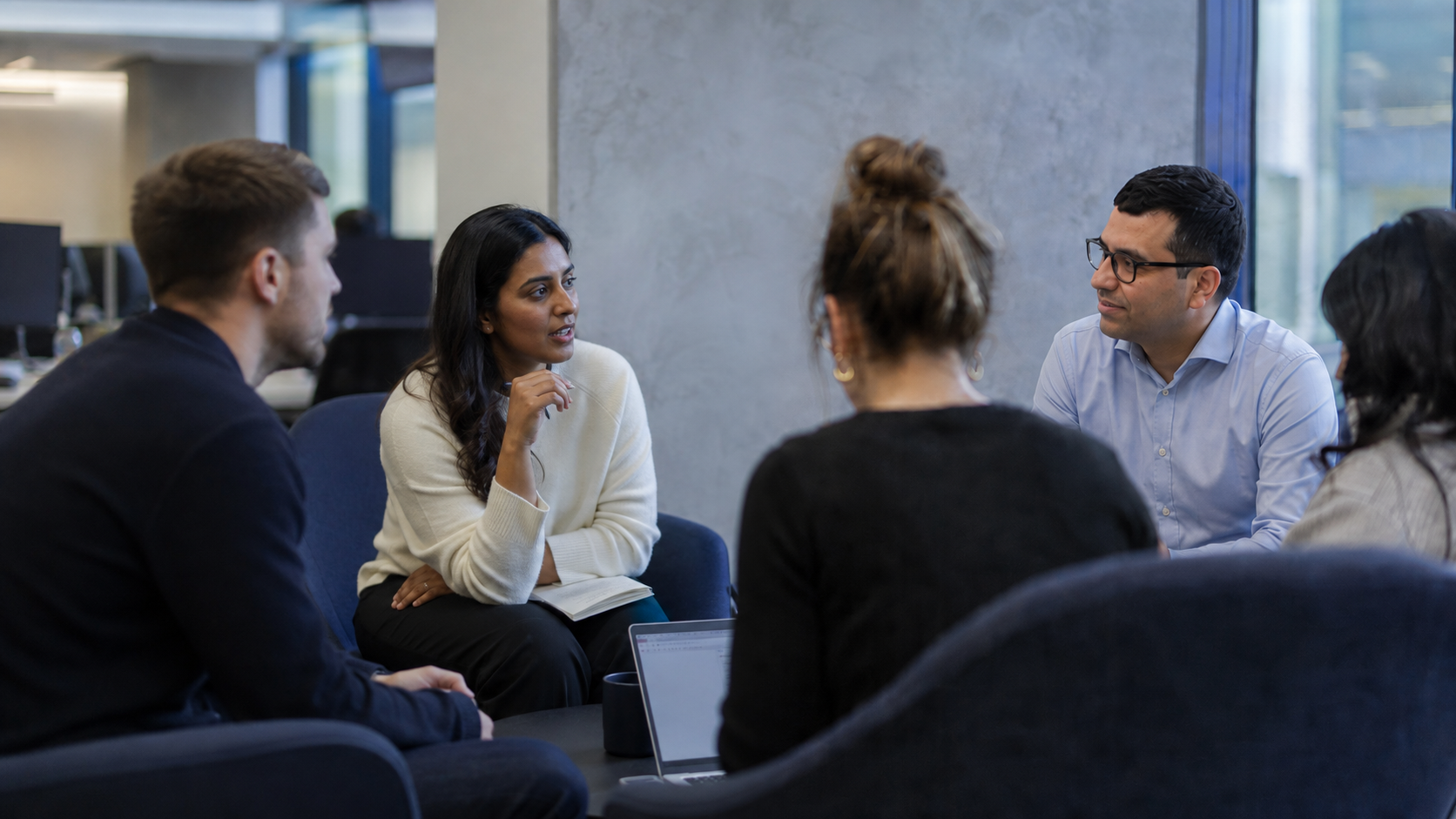 The team in discussion around a table