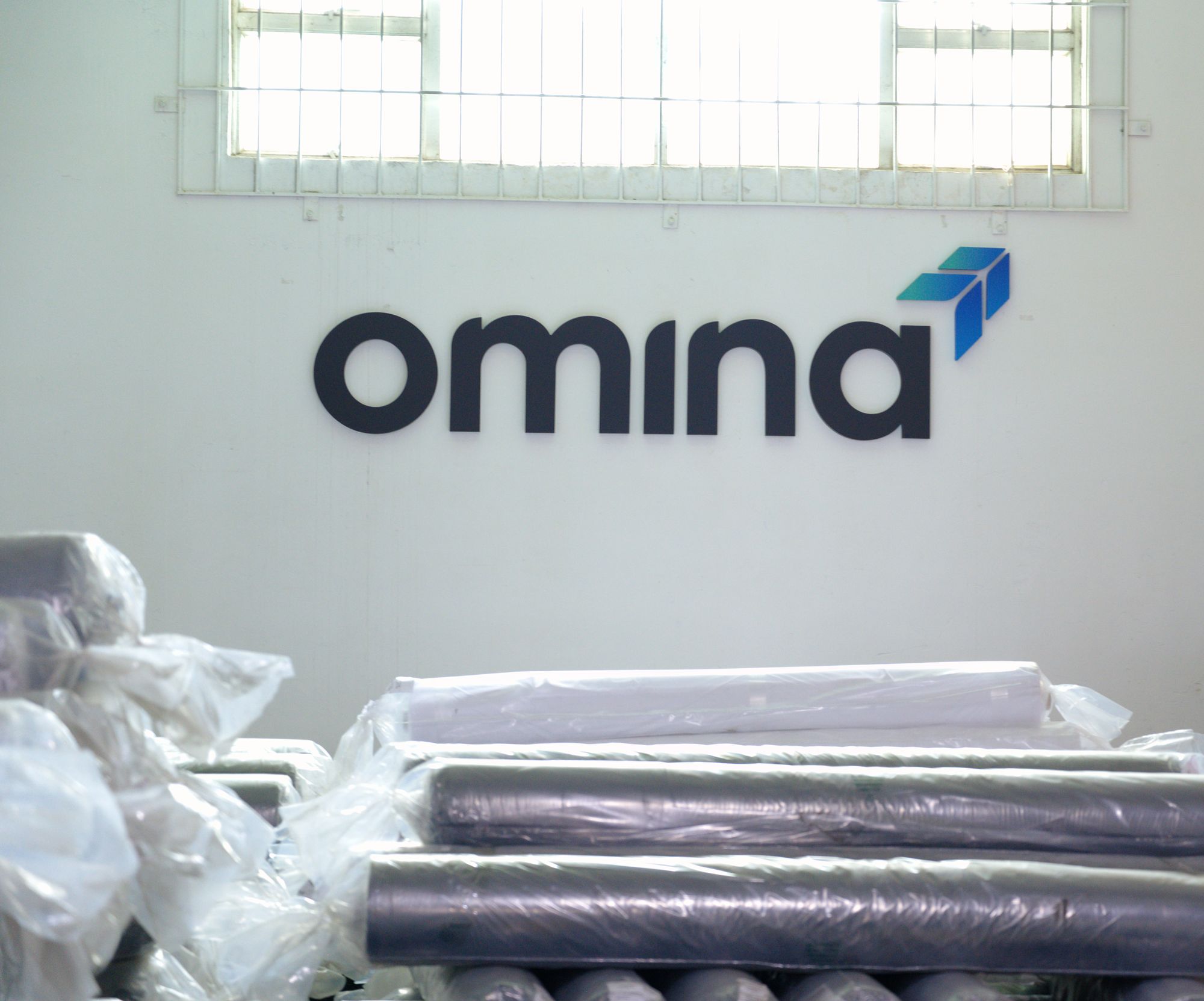Received stock staged in front of the Omina wall