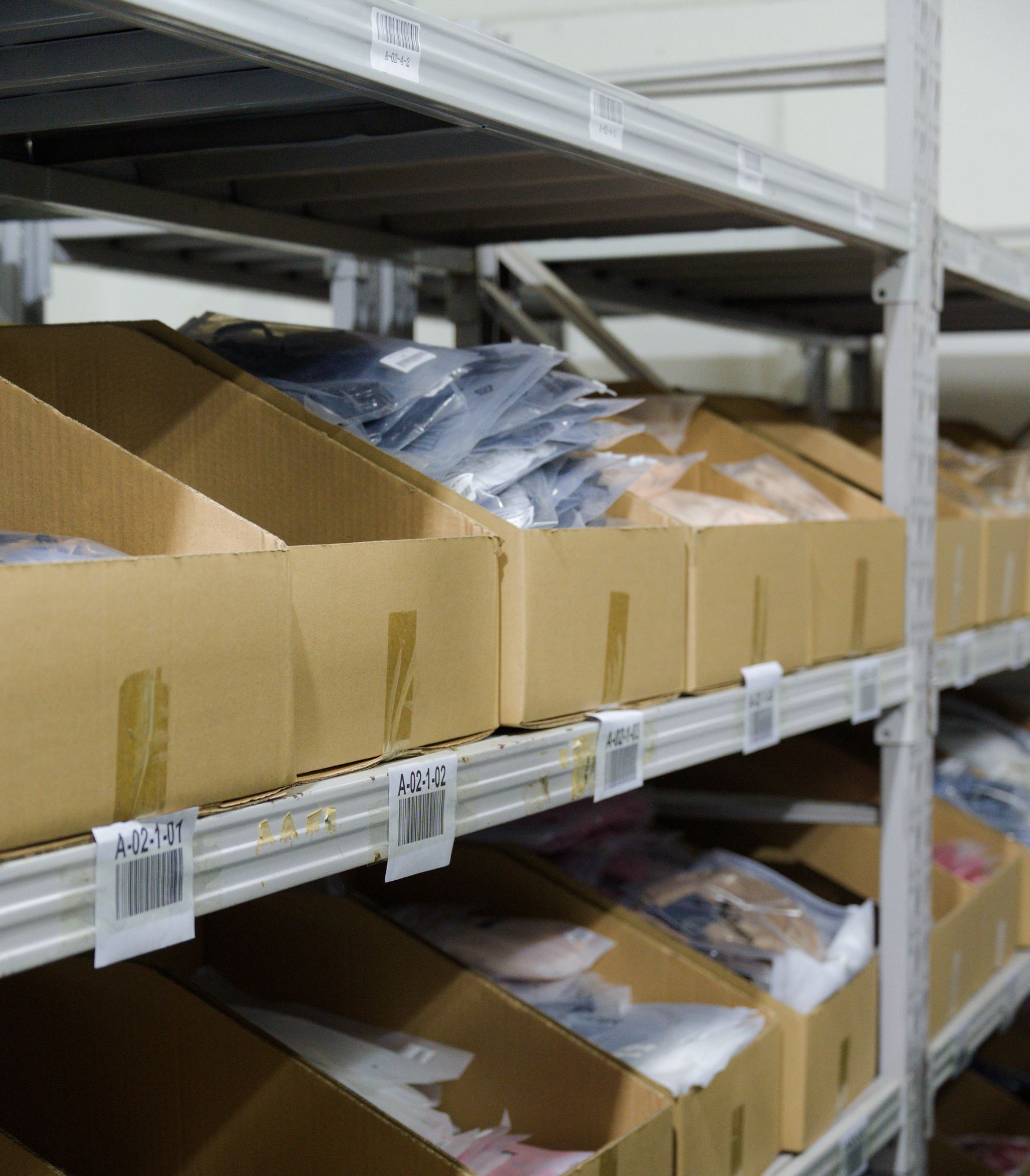 Garment stock on bin shelving at Omina's China facility