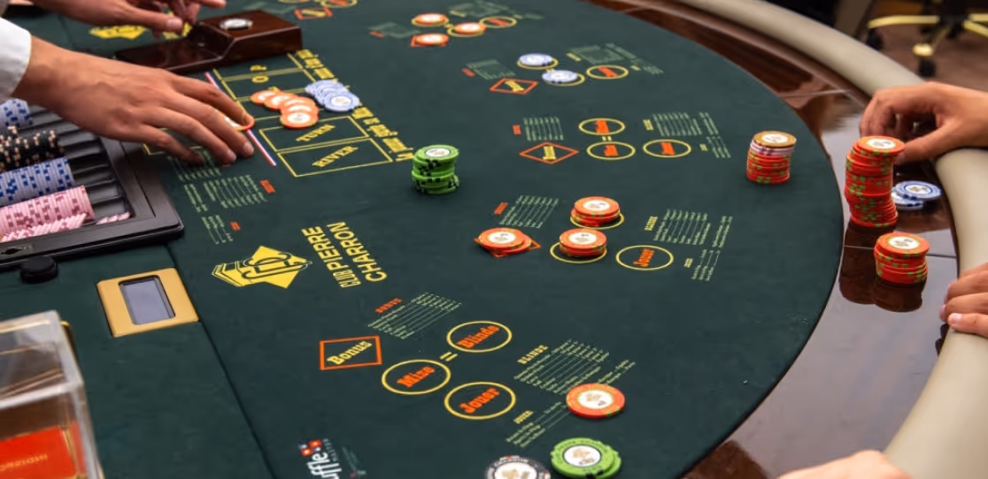 Casino table with green felt showing Club Pierre Charron and players placing colorful chips.